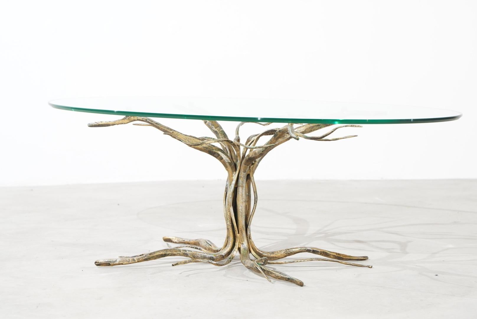 Gorgeous coffee table handcrafted by Italian Artist and Sculptor Salvino Marsura, who passed away in May 2020.
The coffee table shows an amazing tree in heavy gilt wrought iron.
On top is the original crystal glass top with cut edge.
The table is