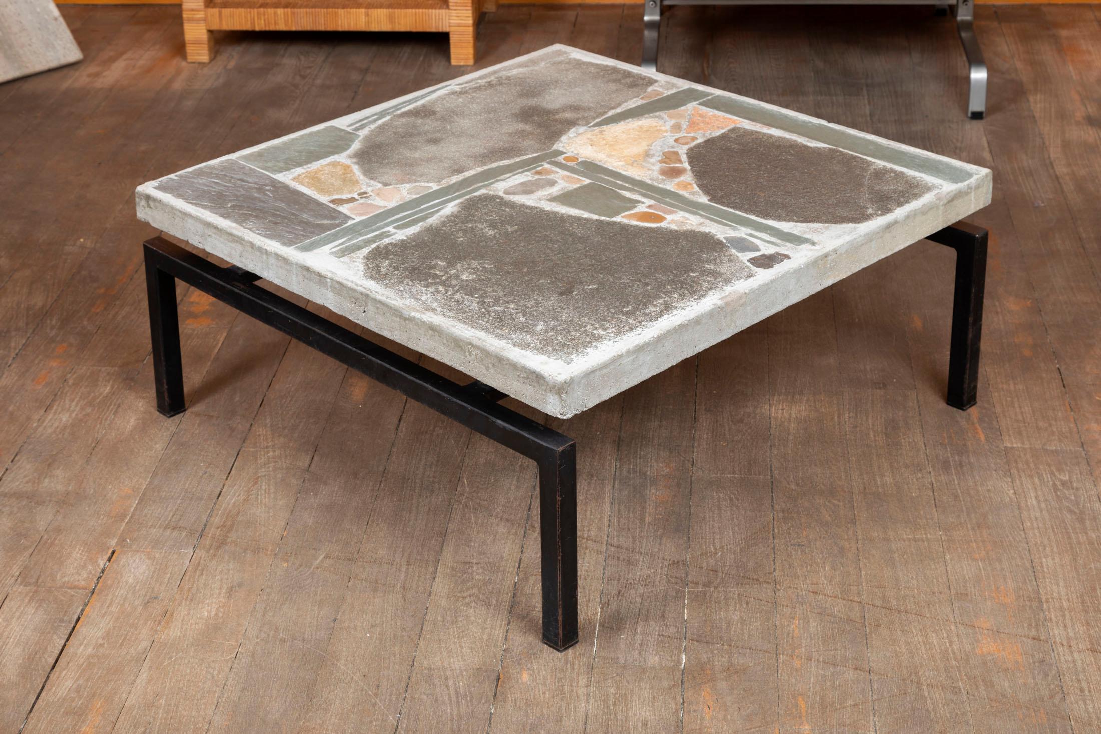 Brutalist coffee table
Concrete top inlaid with slate and stone
Black metal lacquered feet
Design: Paul Kingma
 signed Kingma on the top, with Kingma's child’s hand print under the top.
Netherlands, 1960s.
 
Measures: Height 13.8 inches (35