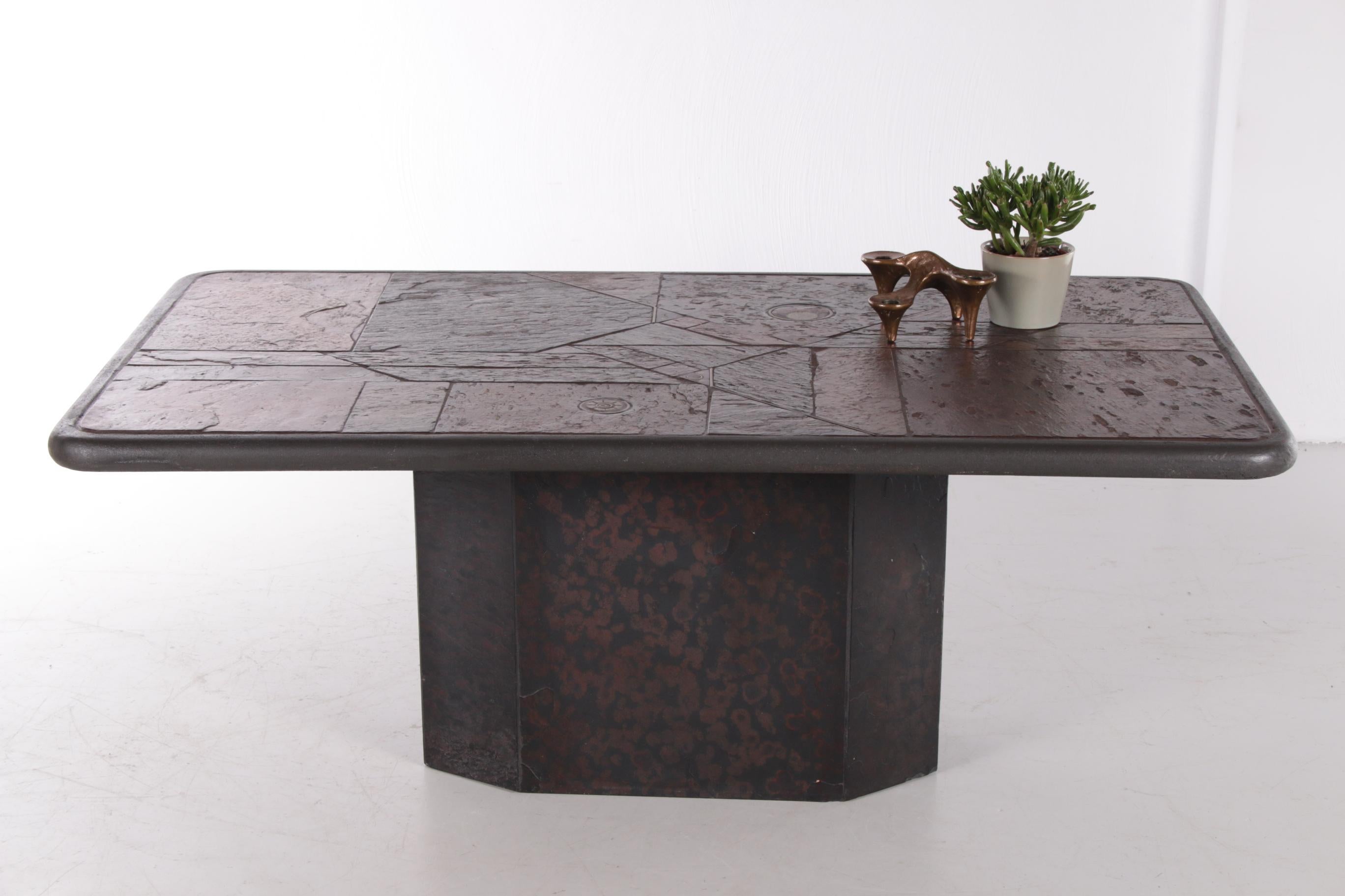 A unique brutalist coffee table by the Dutch artist and designer Paul Kingma, made in the 1980s.

The table is inlaid with pieces of natural stone and brass details. With this, the designer wanted to evoke the idea of the earth and its history,