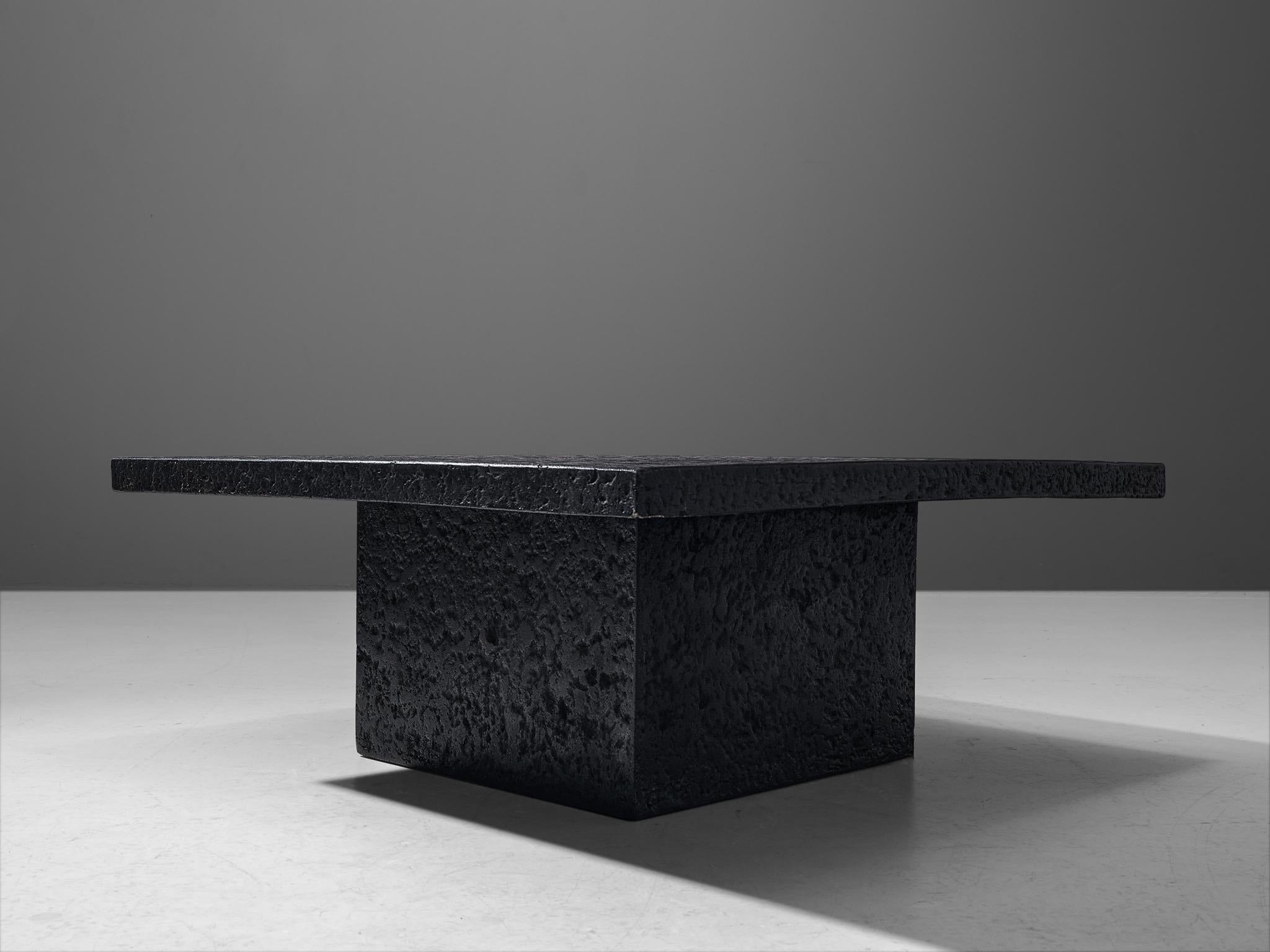 Coffee table, resin, Northern-Europe, 1970s.

This deep black coffee or cocktail table was made in the 1970s. The thick square top is supported by a cubical base. The whole construction is executed in resin which resembles the appearance of stone.