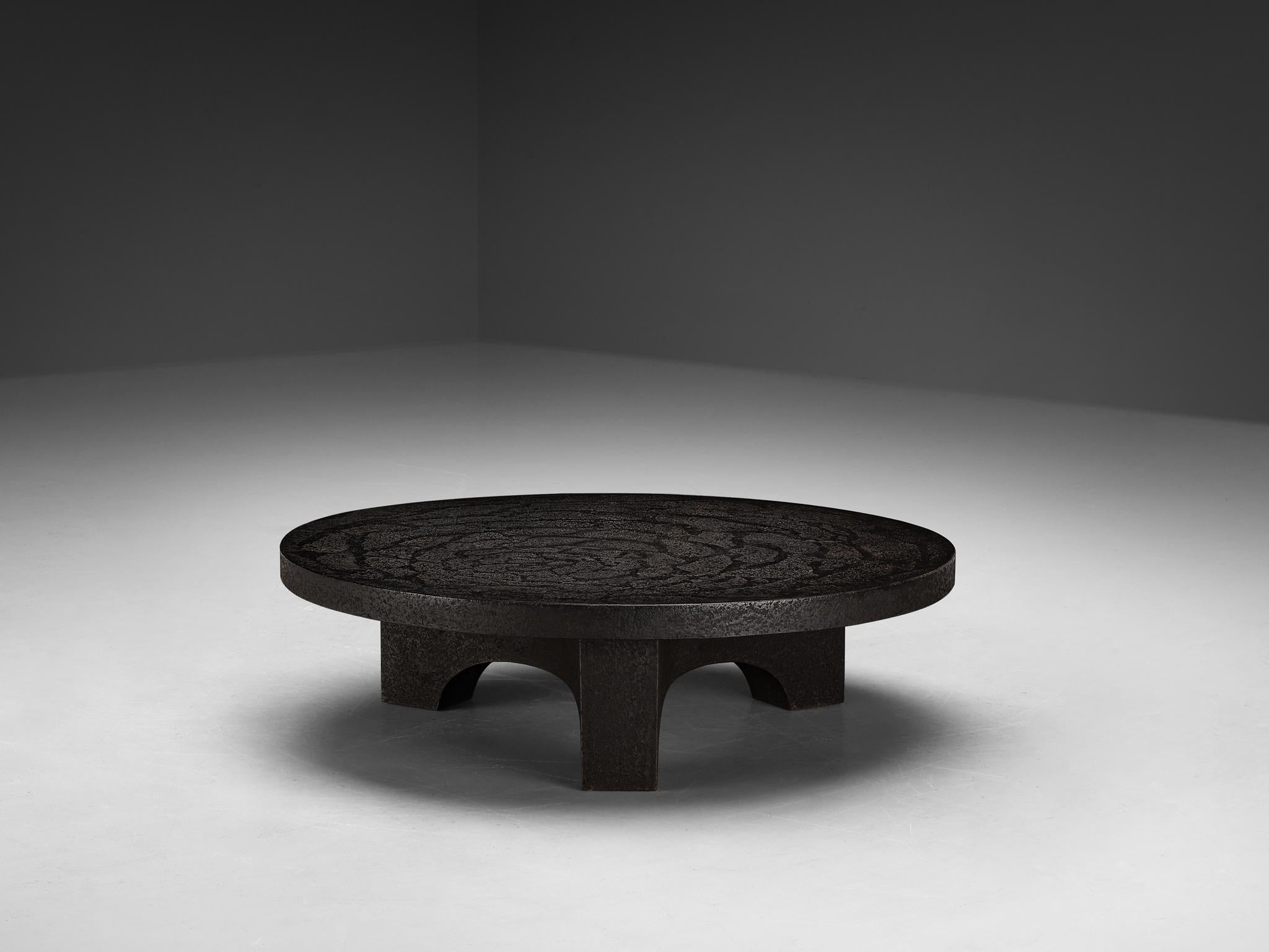 Cocktail table, resin, Northern-Europe, 1970s.

This deep black robust coffee or cocktail table is from the 1970s. The thick round shaped top is supported by a smaller column. The whole construction is executed in resin which resembles the