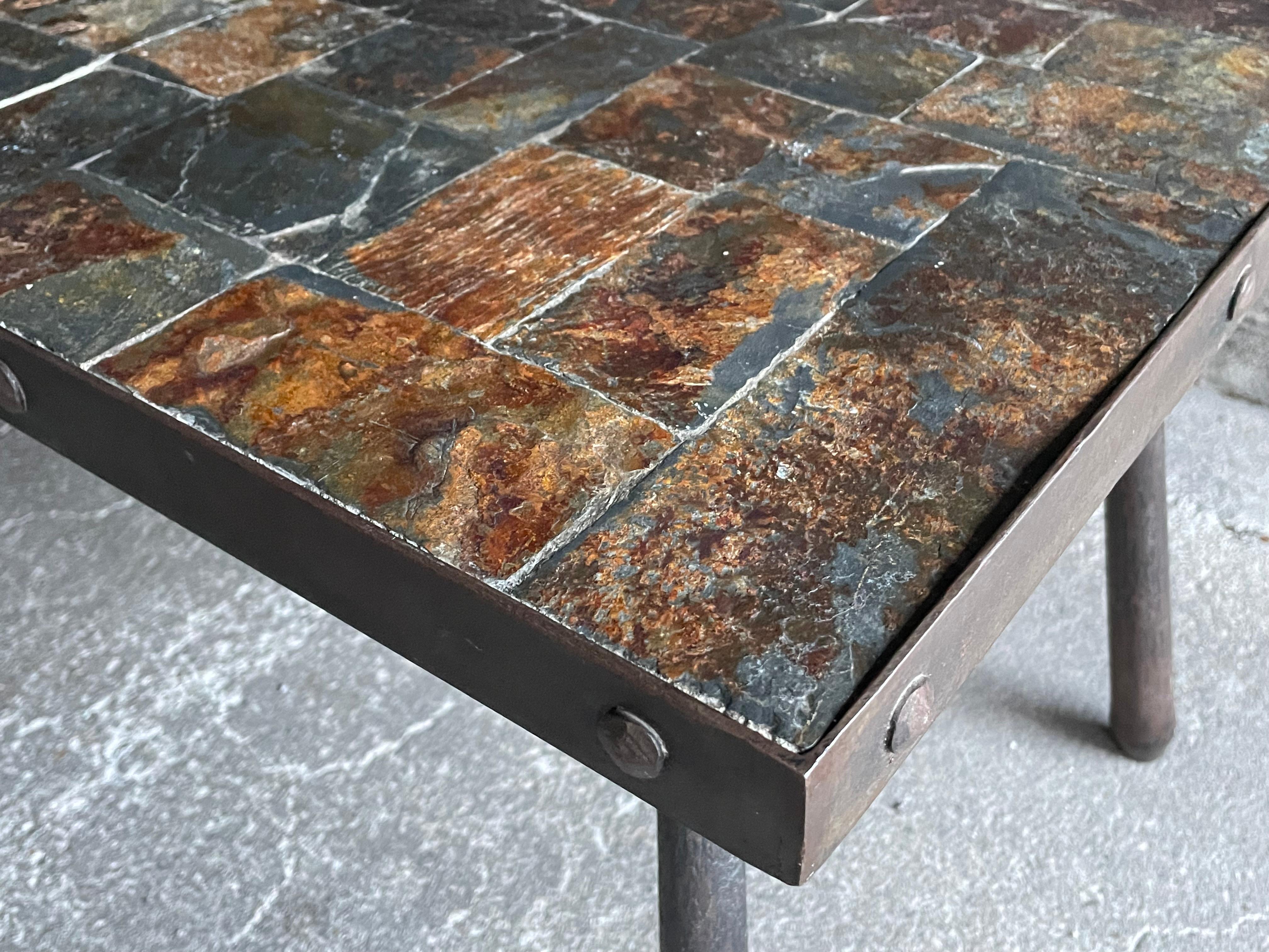 Brutalist coffee table composed of lava stone elements resting on a quadrangular metal base. Around 1960. Dimensions: l90 x p45 x h42 cm.