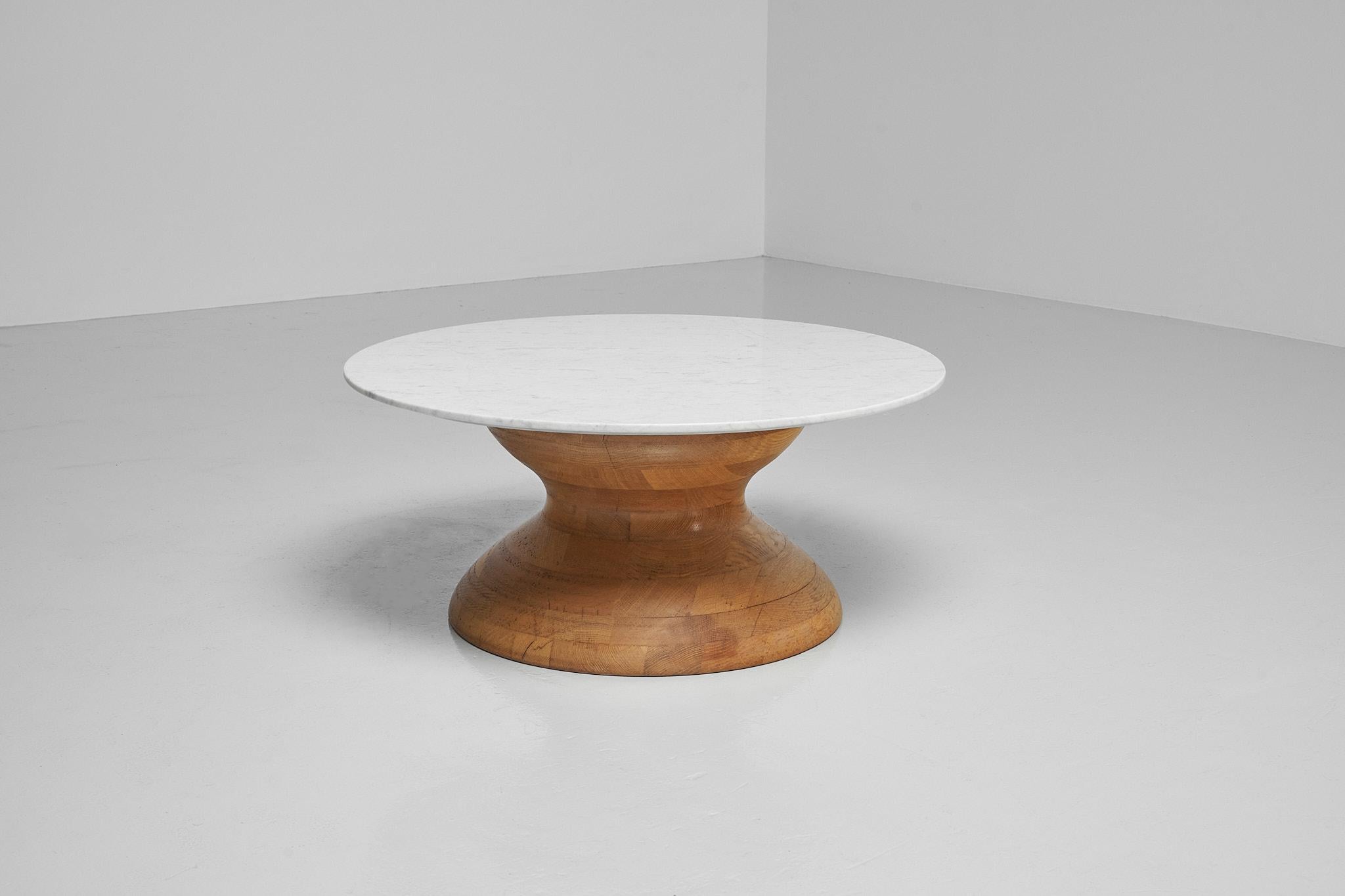 Amazing brutalist shaped coffee table made in France 1960s. Tis stunning sculpted, diabolo shaped coffee table, has a solid oak base. The base consists of different parts of solid oak wood, glued together and sculpted into this beautiful diabolo