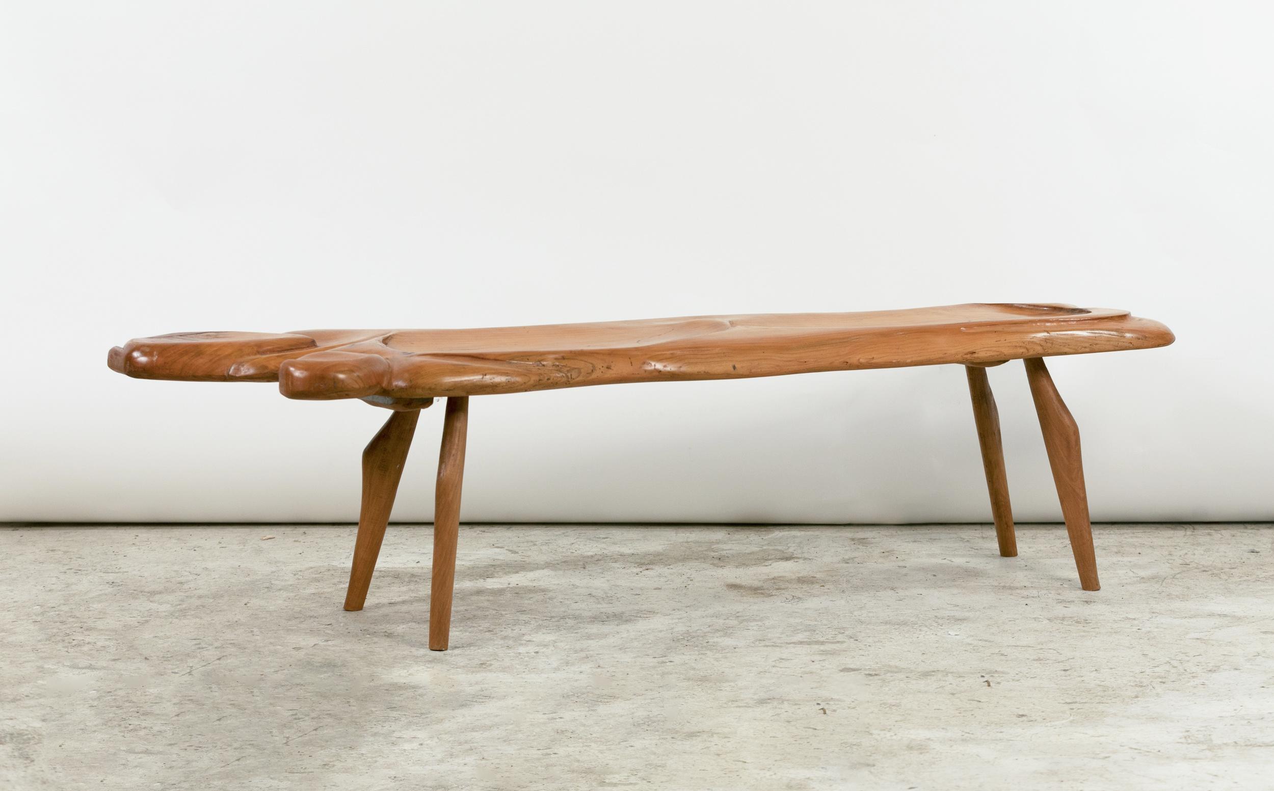 

A very pretty Brutalist-style bench or coffee table in carved elm.
Lenght: 165 cm (65 in /5.42 ft)
Width: 49 cm (19.2 in)
Width in the middle: 38 cm (15 in)
Height: 45 cm (17.7 in)
