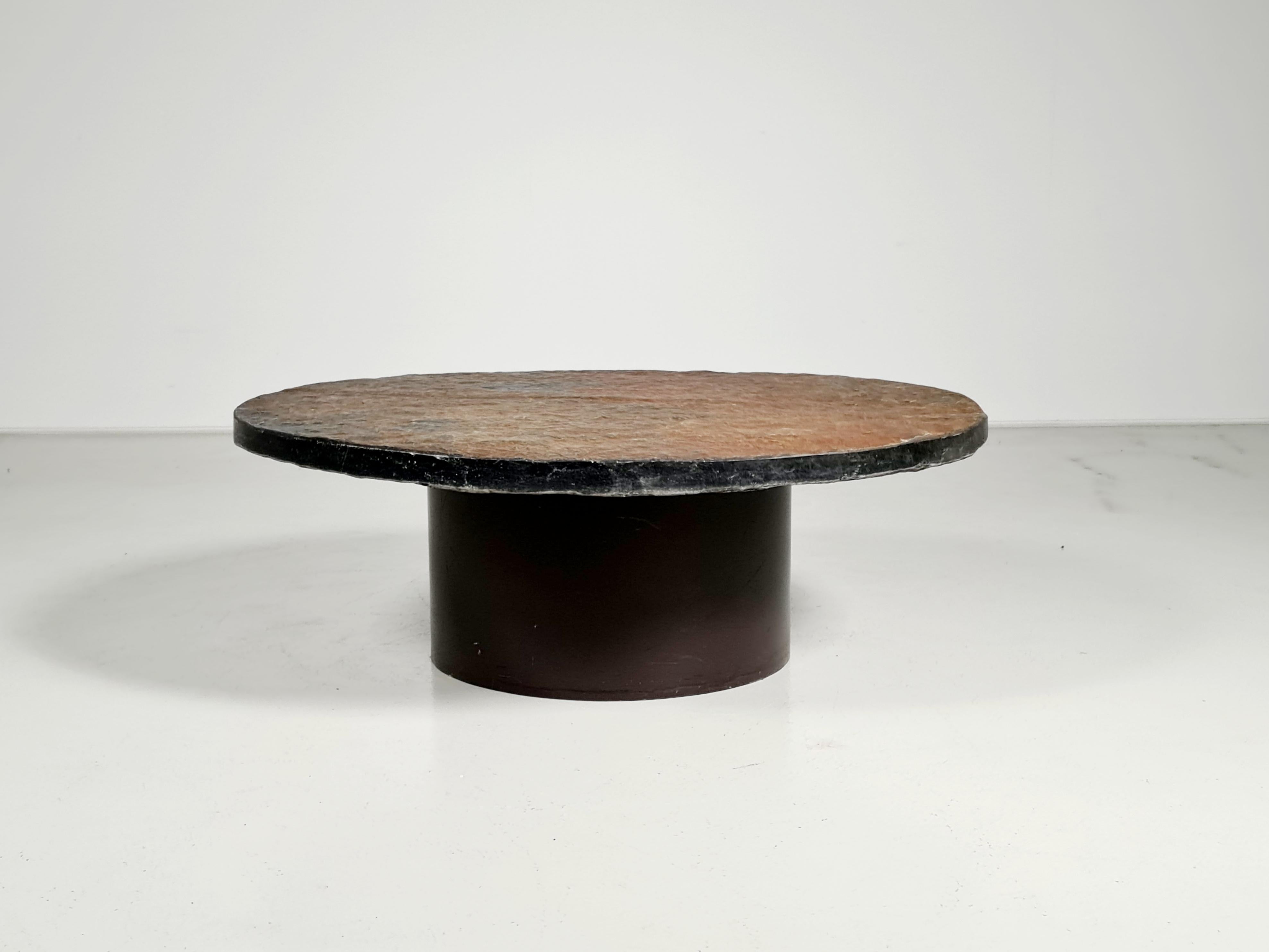 Brutalist slate stone coffee table, Netherlands, 1970
The table has a natural slate top with a beautiful brown/rusty color.

The heavy base is made from lacquered metal and has three adjustable feet.
The robustness of the natural materials