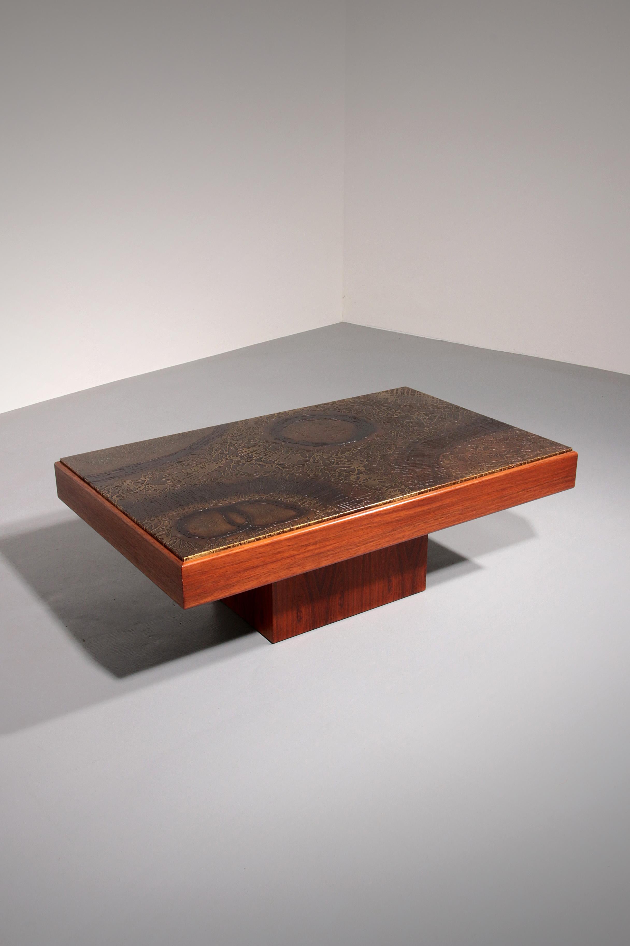 This striking Brutalist coffee table, crafted in Belgium during the 1970s, features a beautifully hand-worked copper top resting on a sculptural solid wood base. Its bold yet minimalist design reflects the essence of Brutalism — raw materials, clean