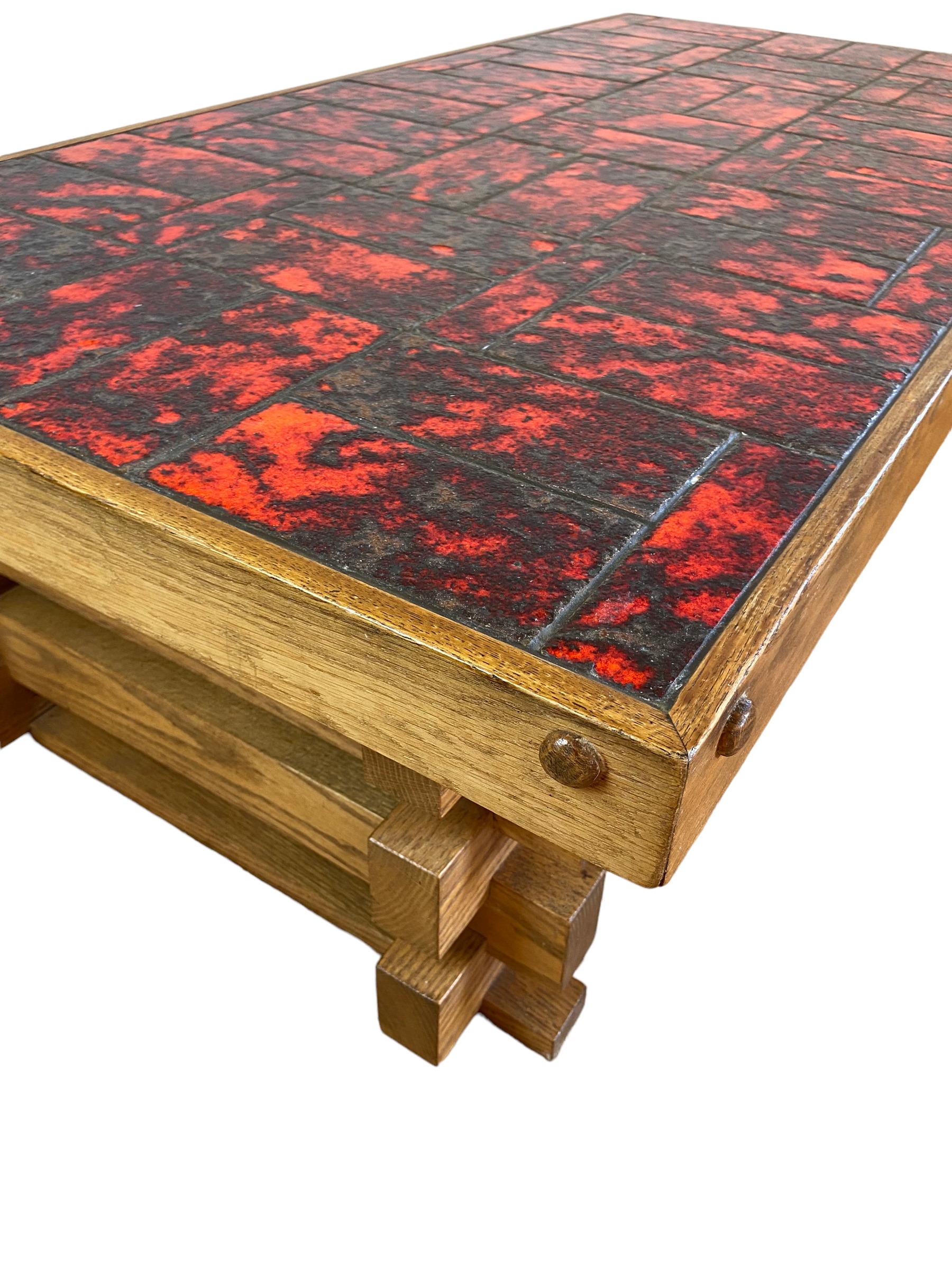 Brutalist coffee table made of oak wood in the 1970s. This unique piece of furniture was made to order in The Netherlands. The top of the table is lined with red glazed tiles and is dismountable.

Measures: height 40 cm width 143 cm depth 74 cm.