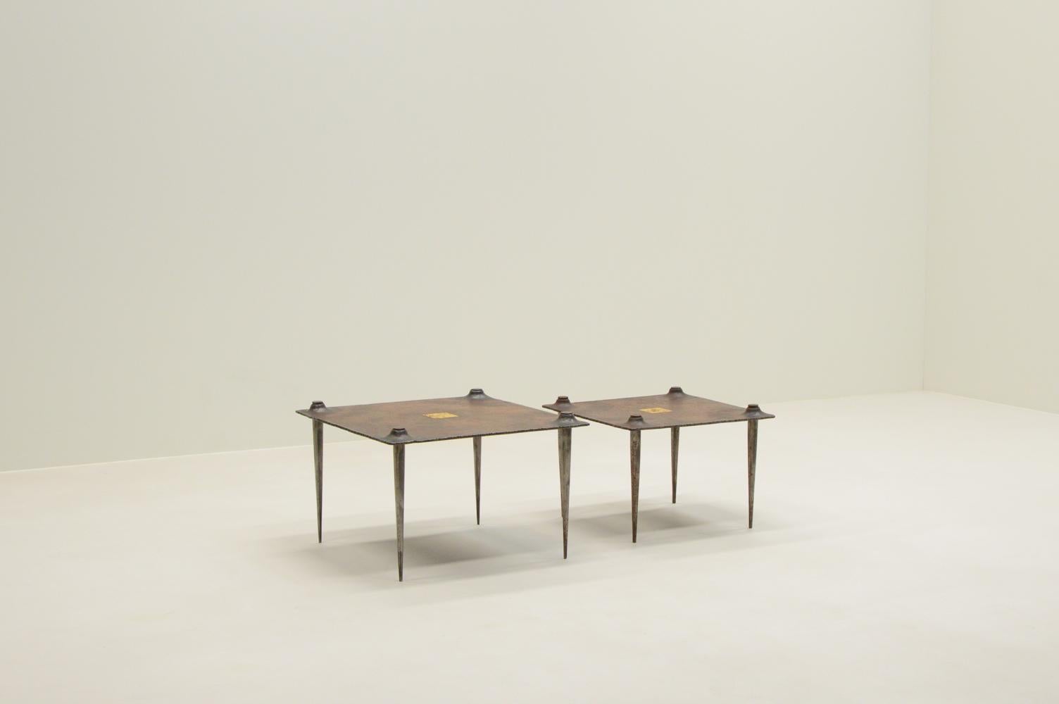 Brutalist side / coffee tables by Idir Mecibah for Smederij Moerman, 1990s Belgium. These tables are part of the Scrab series. Made of forged steel. In the center is a gold leaf square. Idir died at a young age and most of his designs aren’t