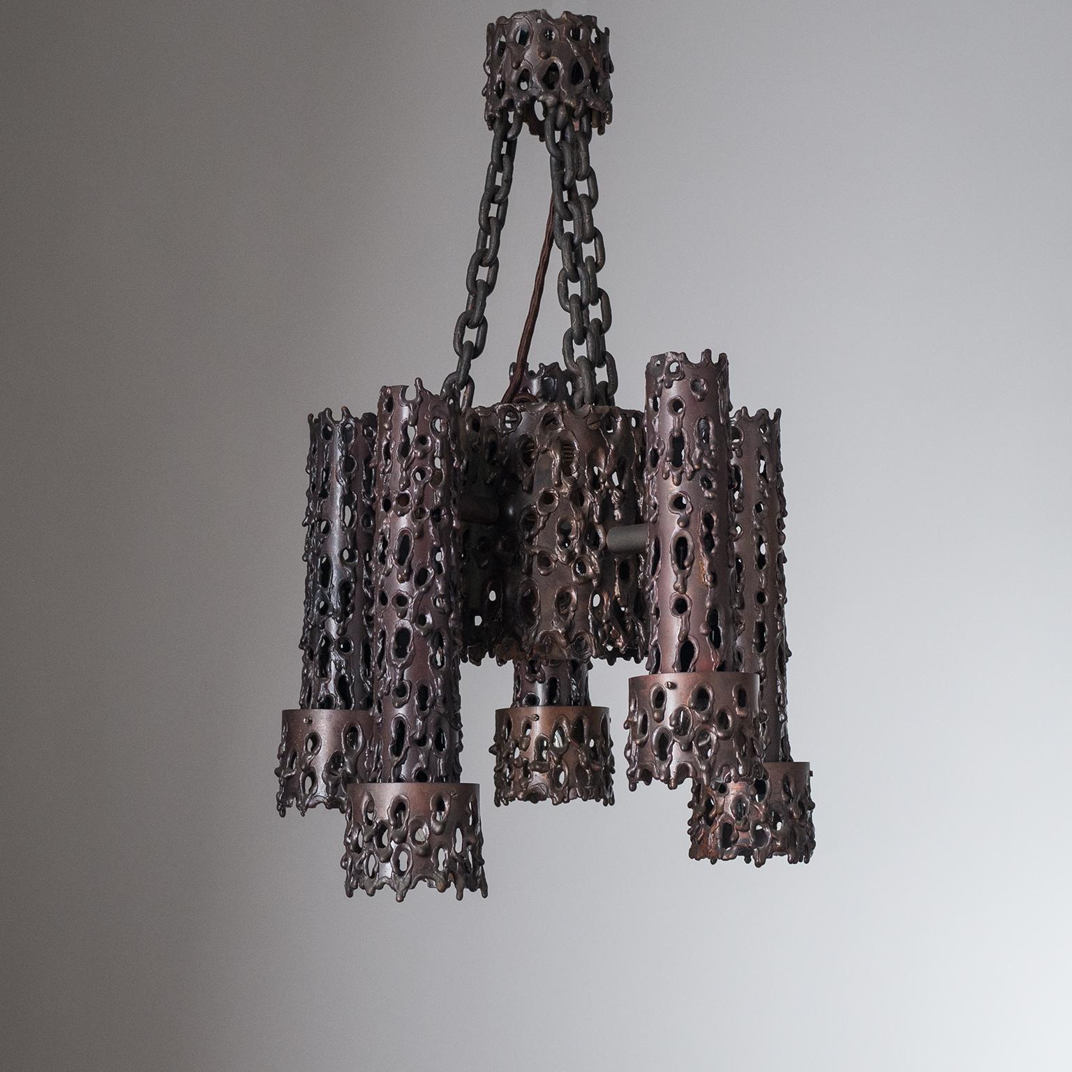 Unique Brutalist ceiling light from the 1960-1970s. Entirely made of solid copper with torch-cut perforations and a lovely age-related patina. Five arms, each with an E14 socket, and a larger central piece with an E27 socket.