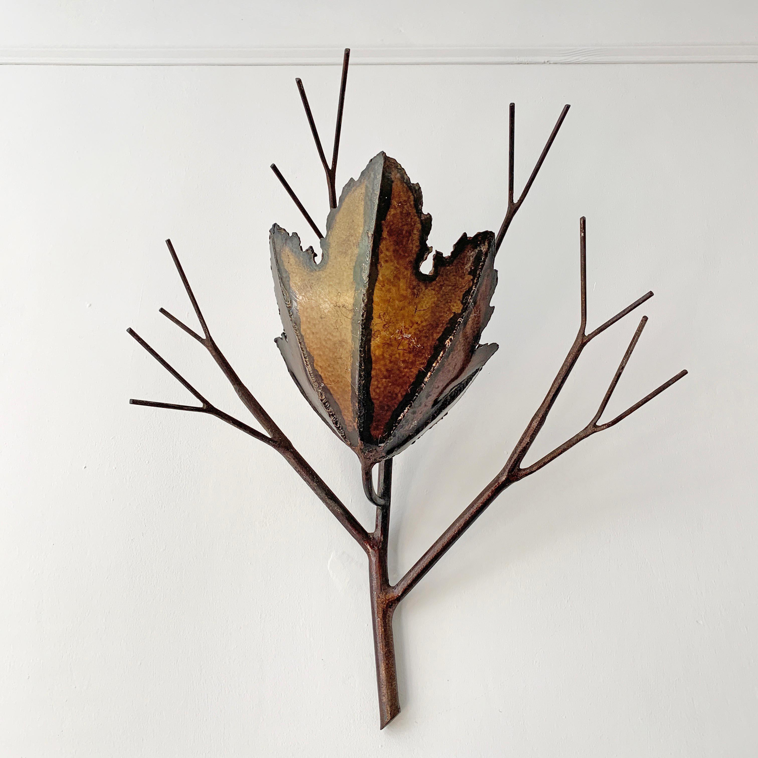 Brutalist copper leaf and branch wall sconce
circa 1960s-1970s
French
Beautiful handcrafted wall sconce in the form of a single leaf in brass and steel stems
The brass leaf and has a single bulb holder hidden behind
There is a hanging hole in