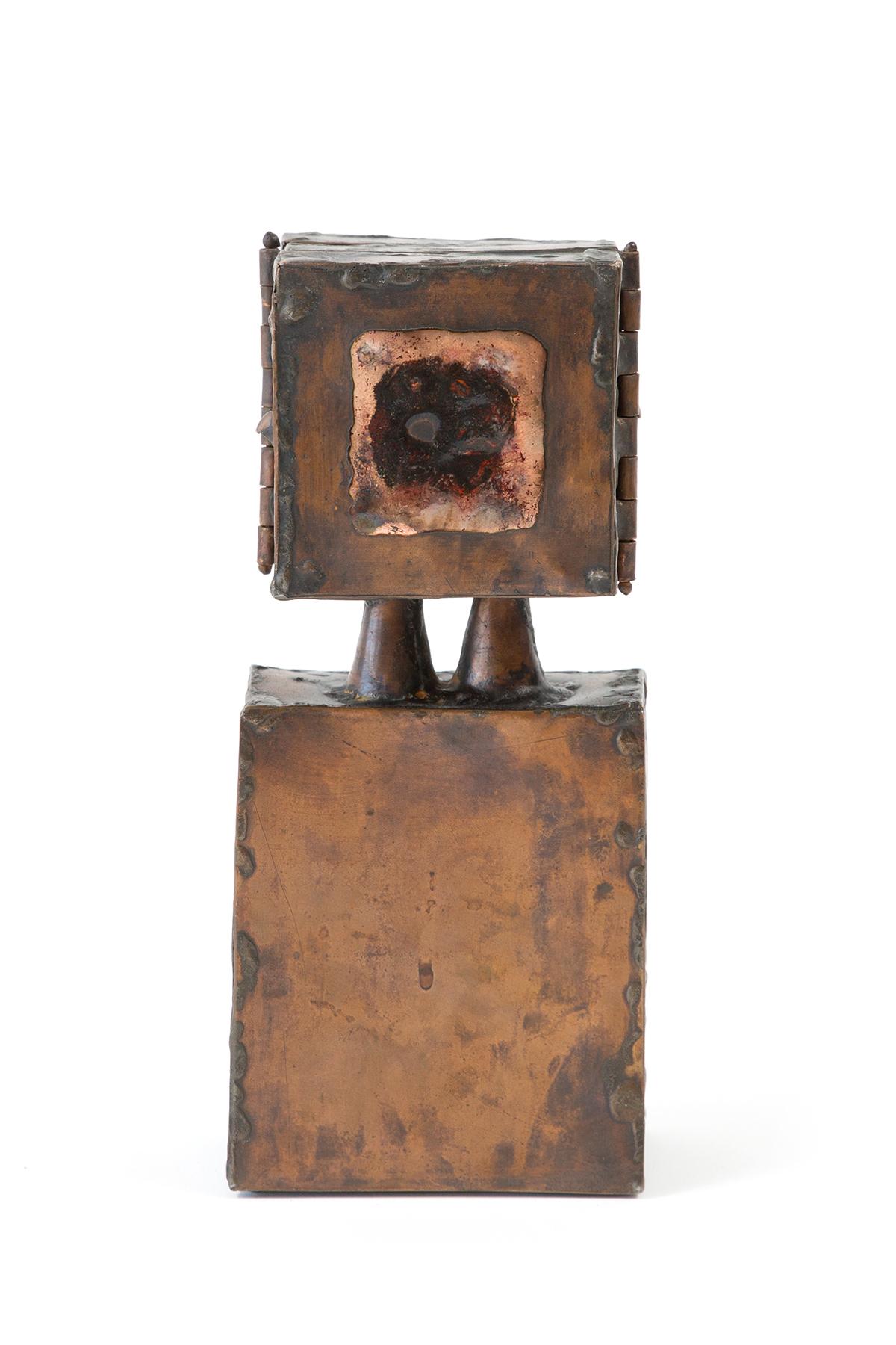 Copper and enamel sculpture with a signature by artist David Laughlin features a hinged top portion that reveals a modernist face, a circular abstracted cut-out and an open circle in the centre when both sides are opened. The hinged doors, when