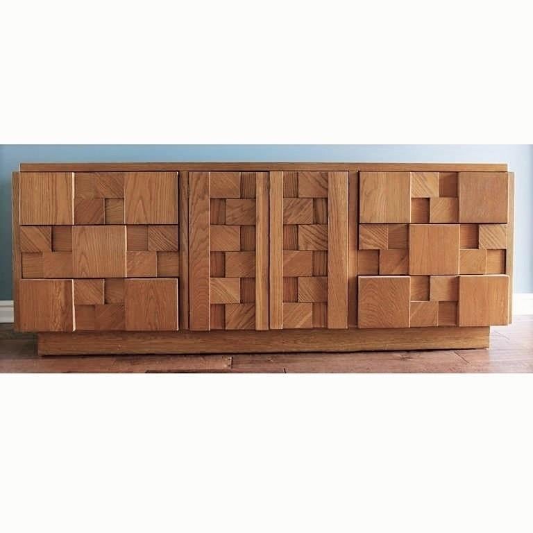This strikingly handsome cubist fronted six-drawer credenza in natural wood finish made by The Lane Furniture Company in the 1960s, reference to the Paul Evans Cityscape line. This dresser has two doors in the center section that open to reveal a