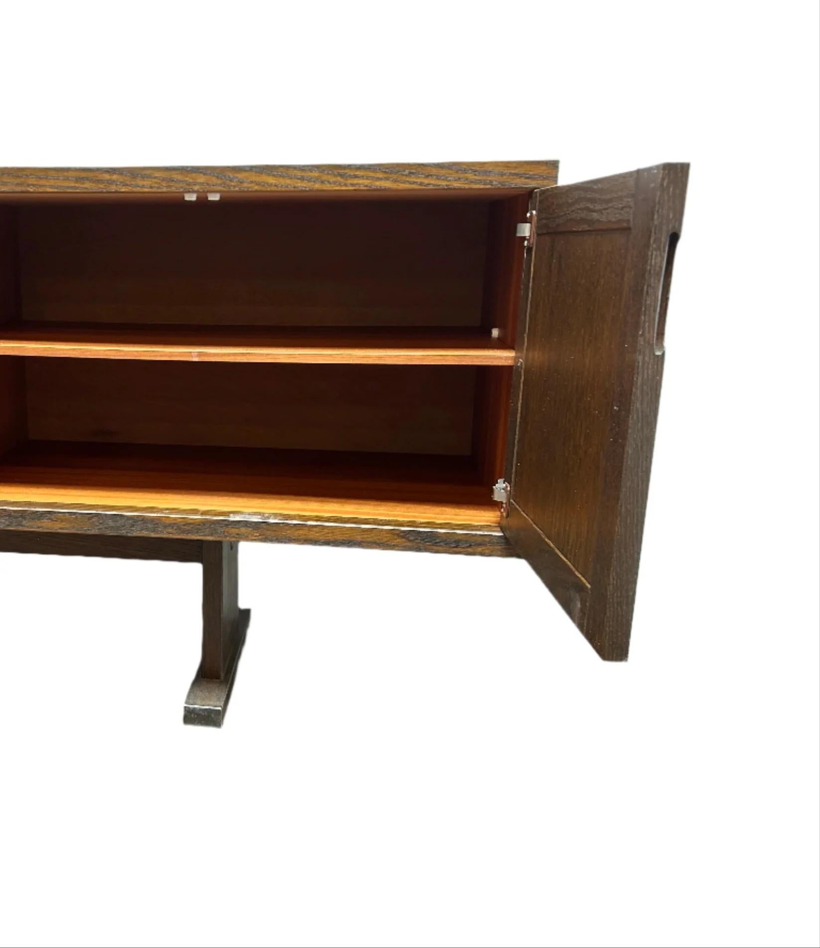 Bold. Textural. Unapologetically artistic. This vintage mid-century console features standout Brutalist detailing with hand-sculpted ceramic tiles across the front panels—each with a unique glaze pattern in earth-toned hues of sand, umber, and