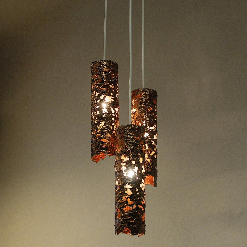 Stunning 1960`s brutalist copper pendant lamp by Aimo Tukianinen, Finland-  consisting of three cylinder shaped lampshades suspended from a large cable cup on the top. Each shade has its own cable and they all gather in the copper cup on top of the