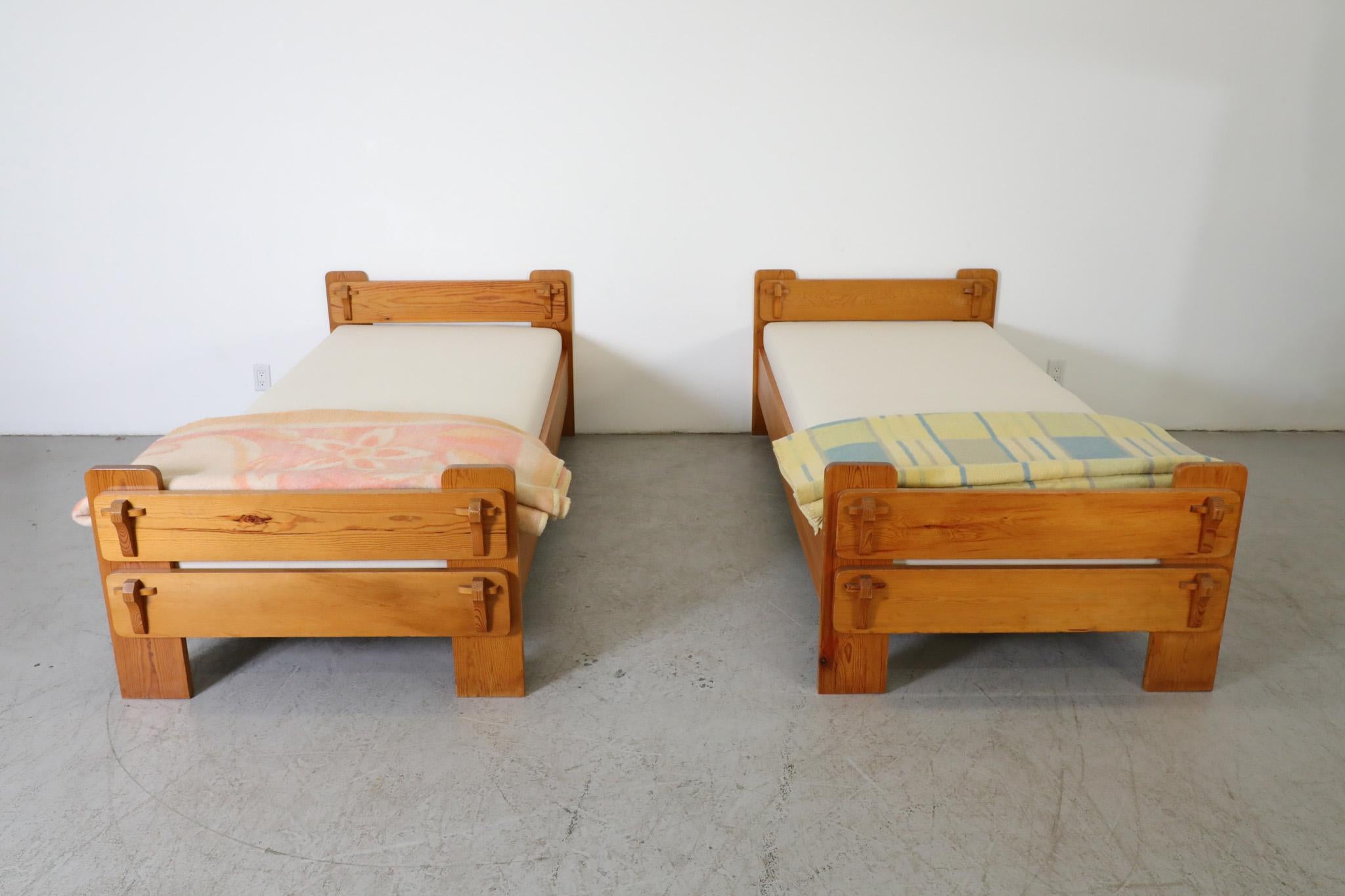 Mid-Century, Pine frame twin beds with new, white canvas mattresses. Attributed to Belgian manufacturer De Puydt The bed frames are outfitted with a tilting mechanism for raising the upper portion of the mattress but, due to the thickness of the
