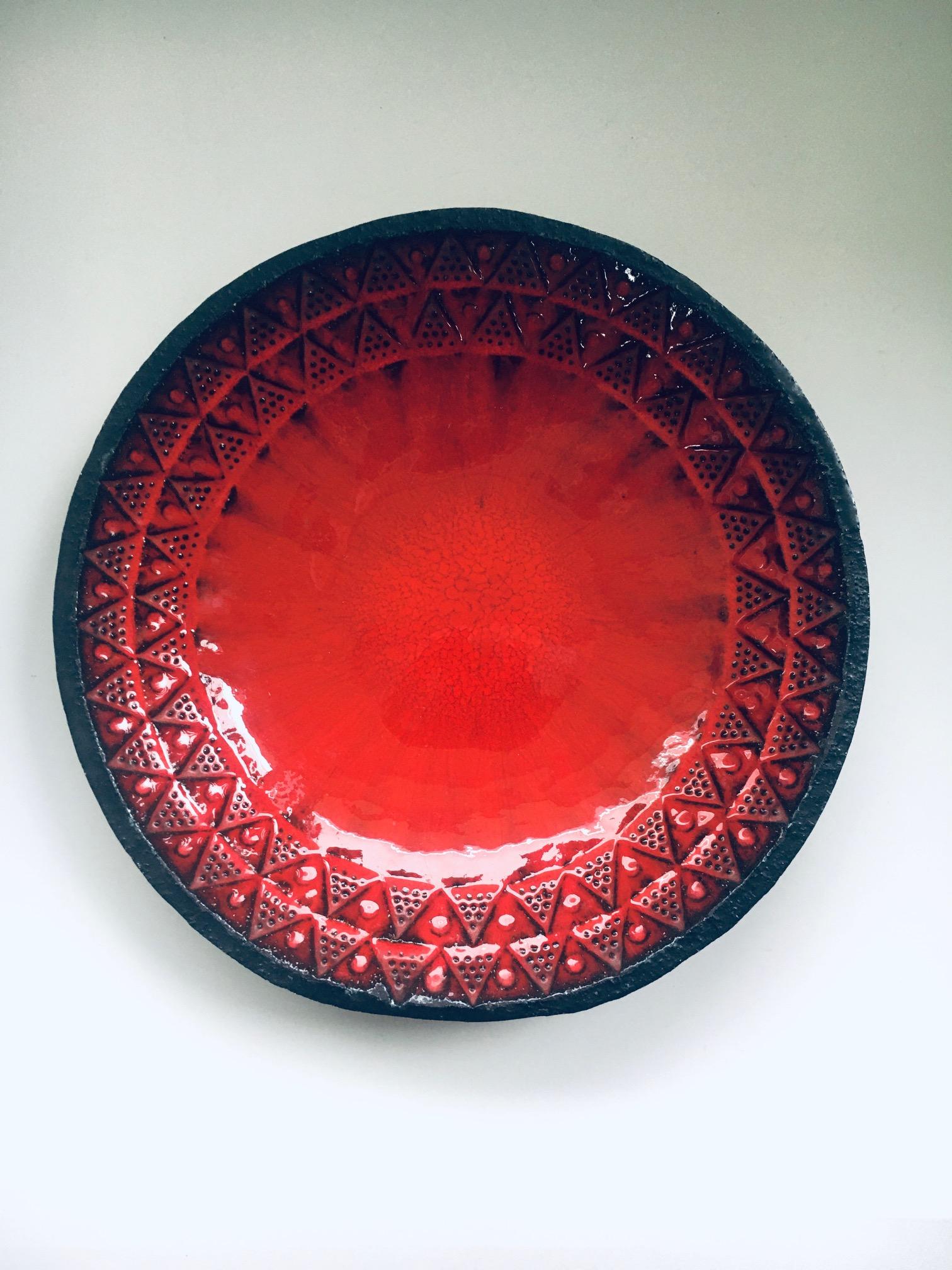 Vintage Midcentury Brutalist Design Art Ceramic Bowl by Jan Nolf for Perignem ceramic pottery art studio, made in Belgium 1950's / 60's period. Vibrant red glazed on the inside with black on the outer edge and outside of this impressive bowl.