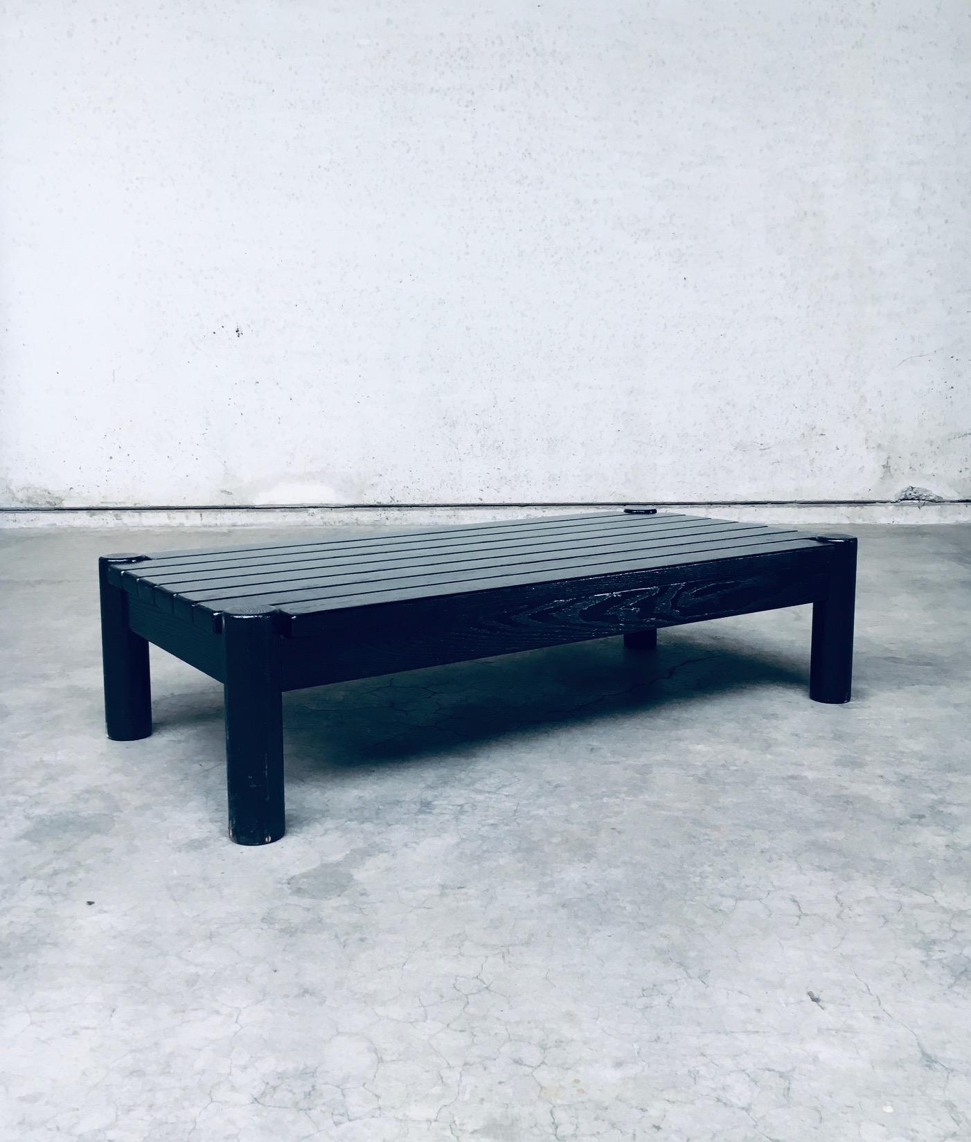 Brutalist Dutch Design Black Stained Oak Coffee Table. Made in the Netherlands, 1960's / 70's period. Heavy and solid coffee table in black stained oak. 4 pilar legs with thick planks as top. Robust in design and production. This comes in good