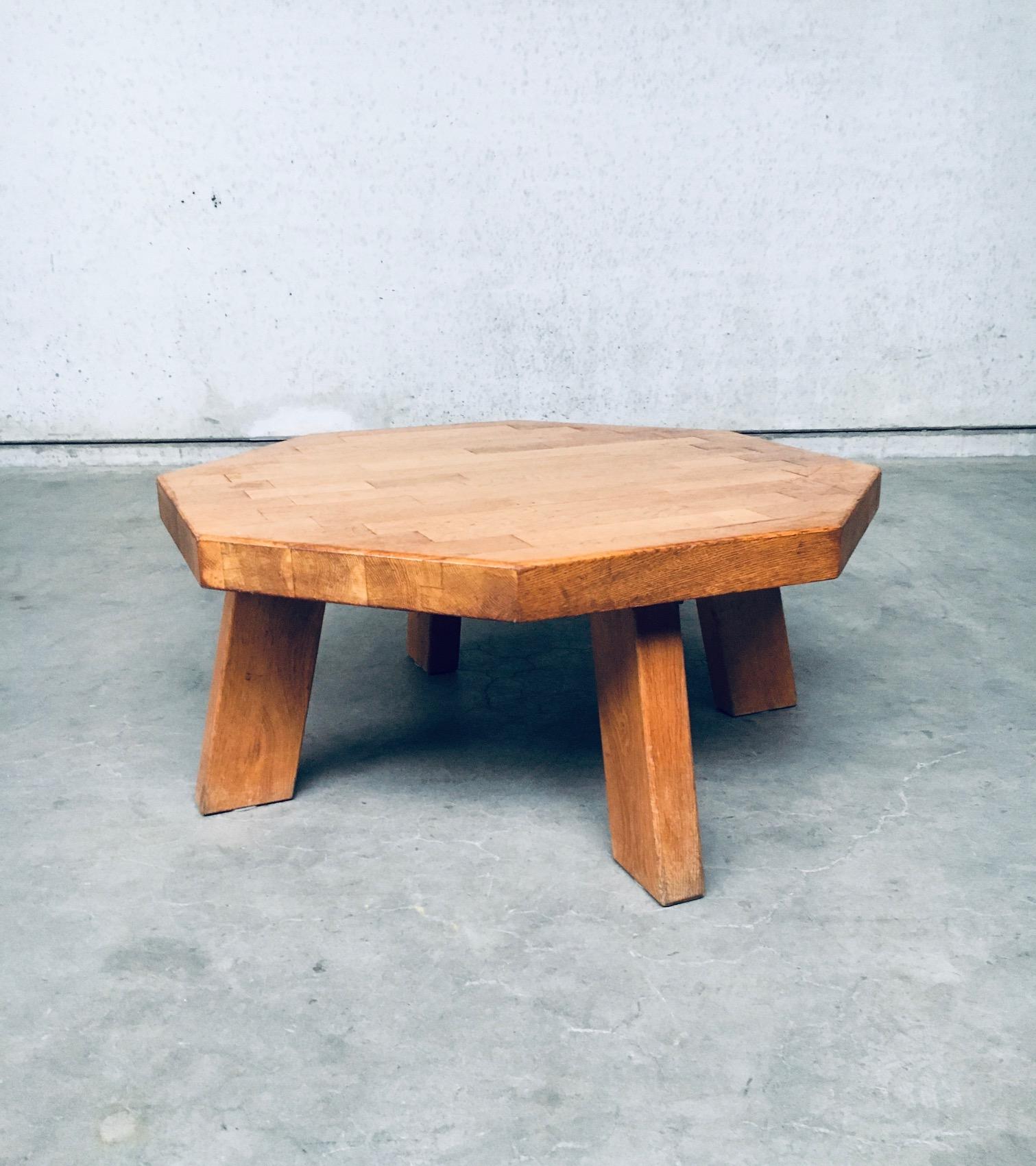 Vintage mid-century Dutch Brutalist design solid oak octagonal coffee table by Meubelfabriek Oisterwijk, made in the Netherlands in the 1960's period. In the style of Charlotte Perriand / Pierre Jeanneret. Solid oak constructed heavy coffee table.