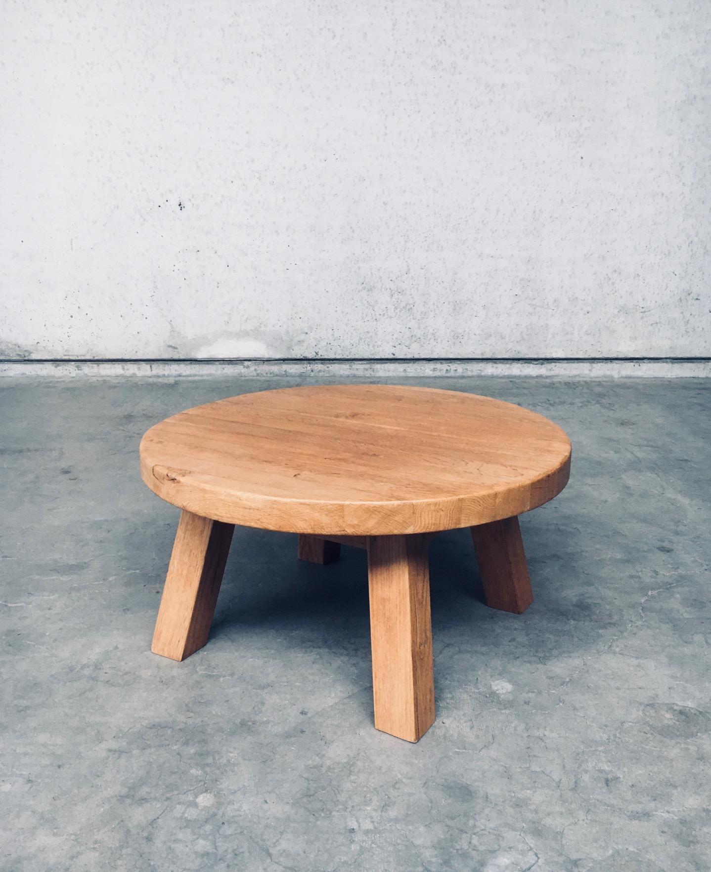 Vintage Brutalist Dutch Design Oak Round Coffee Table. Made in the Netherlands, 1960's period. Solid light oak constructed coffee table. Round table top with 4 rectagular feet. This comes in very good condition with minor signs of it's use and age.