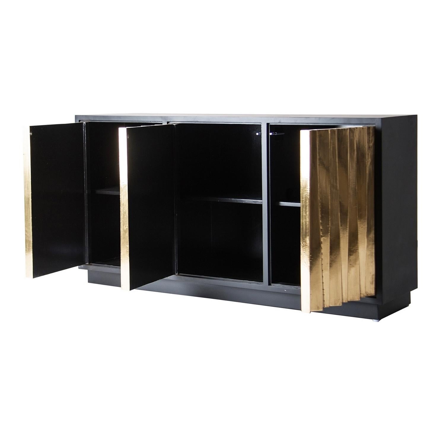 Brutalist style sparkling and sophisticated sideboard with graphic panels doors adorned with brass leaf and opening on shelves.
