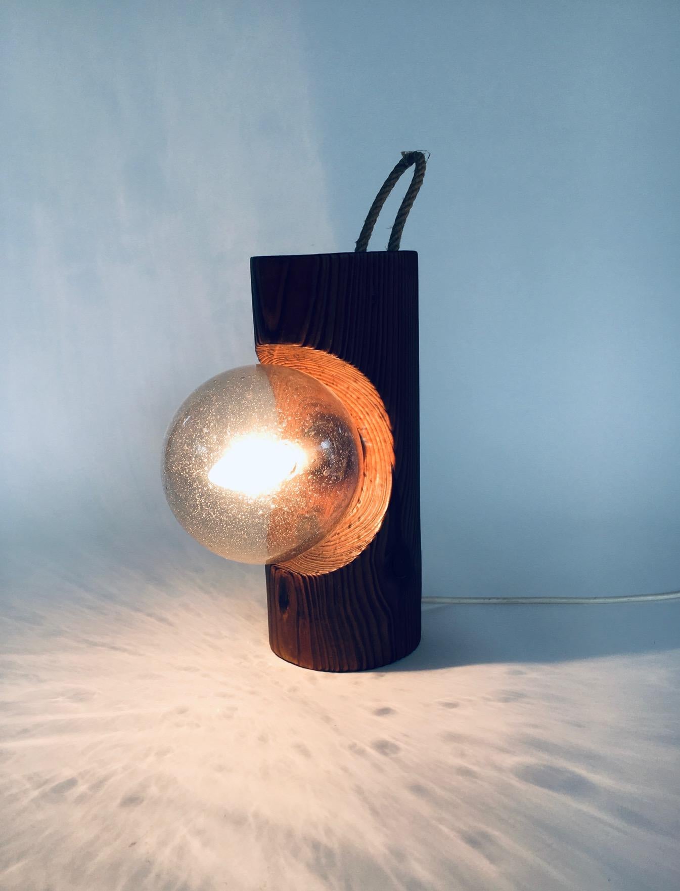 Vintage Brutalist Design Wood & Glass Table or Wall Lamp by Temde Leuchten. Made in Switzerland, 1960's period. Pine wood log with handblown bubble glass ball and rope handle. This can be used as a table lamp or hung on the wall, as the back is