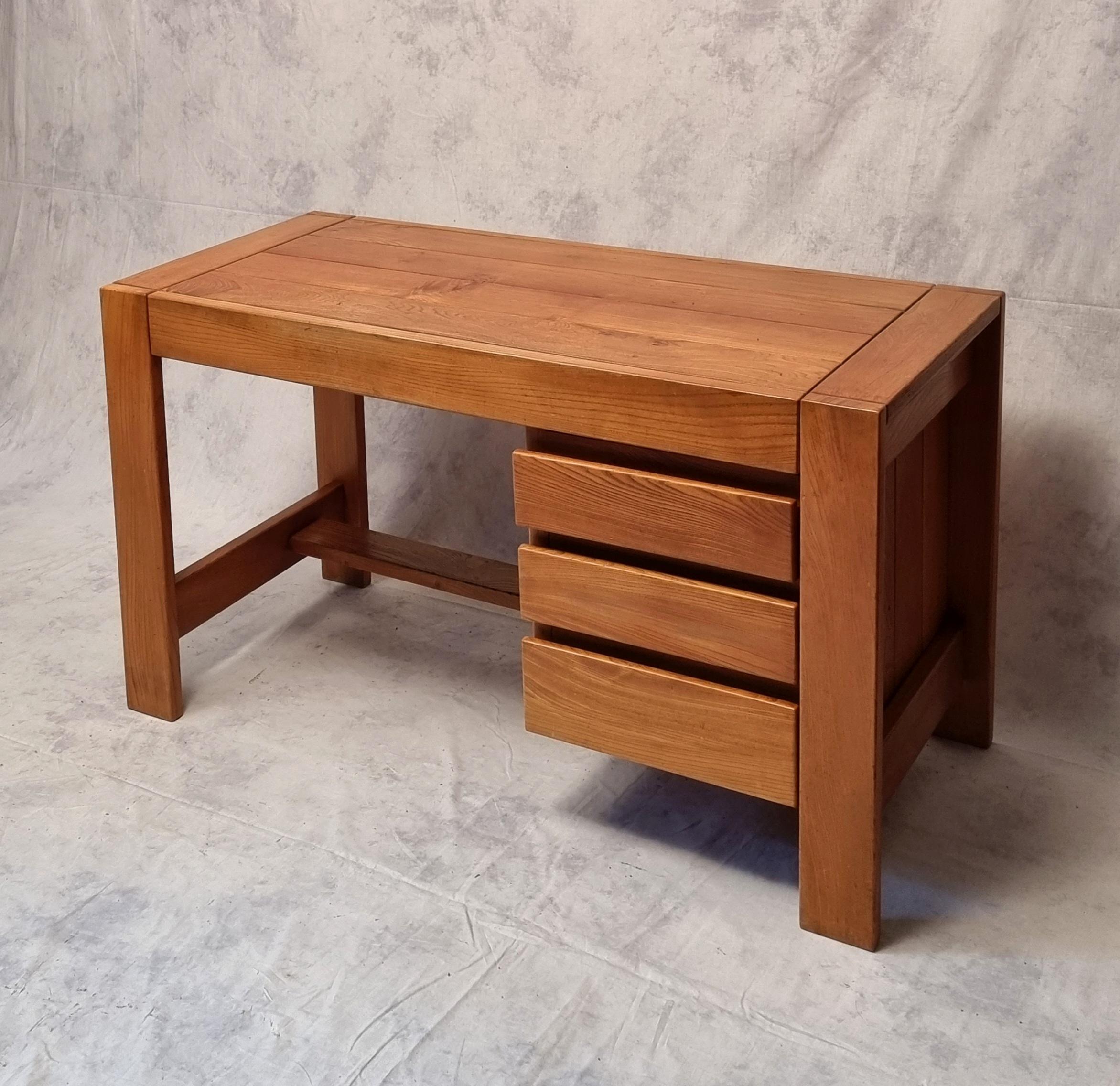 Maison Regain desk from the 1960s.
 A typical piece of the French brutalist style, the Maison Regain serves as a benchmark in terms of furniture in this style with Pierre Chapo.
 It is all solid elm.
 Its design and quality make this desk a piece