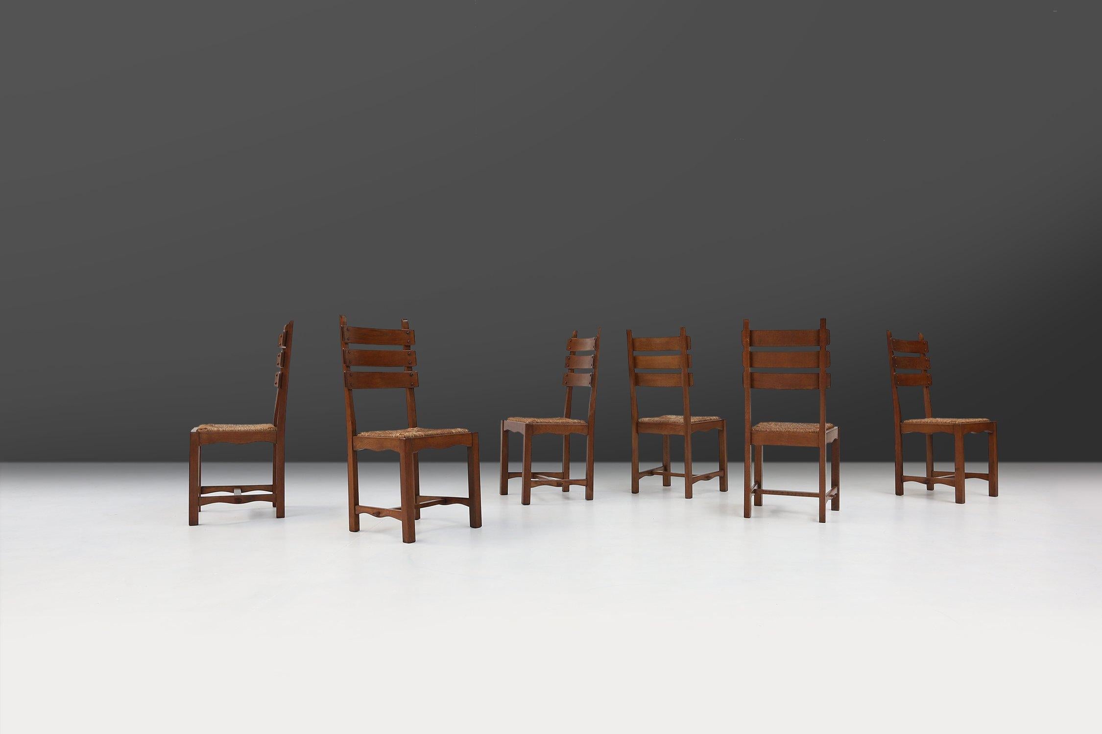 Belgium / 1950 / set dining chairs / oak, wicker / Mid-century / Brutalist

Impressive set of six Belgian brutalist dining chairs. With its ladder backrests and wicker seats they were designed to create a chair that was comfortable, organic, and