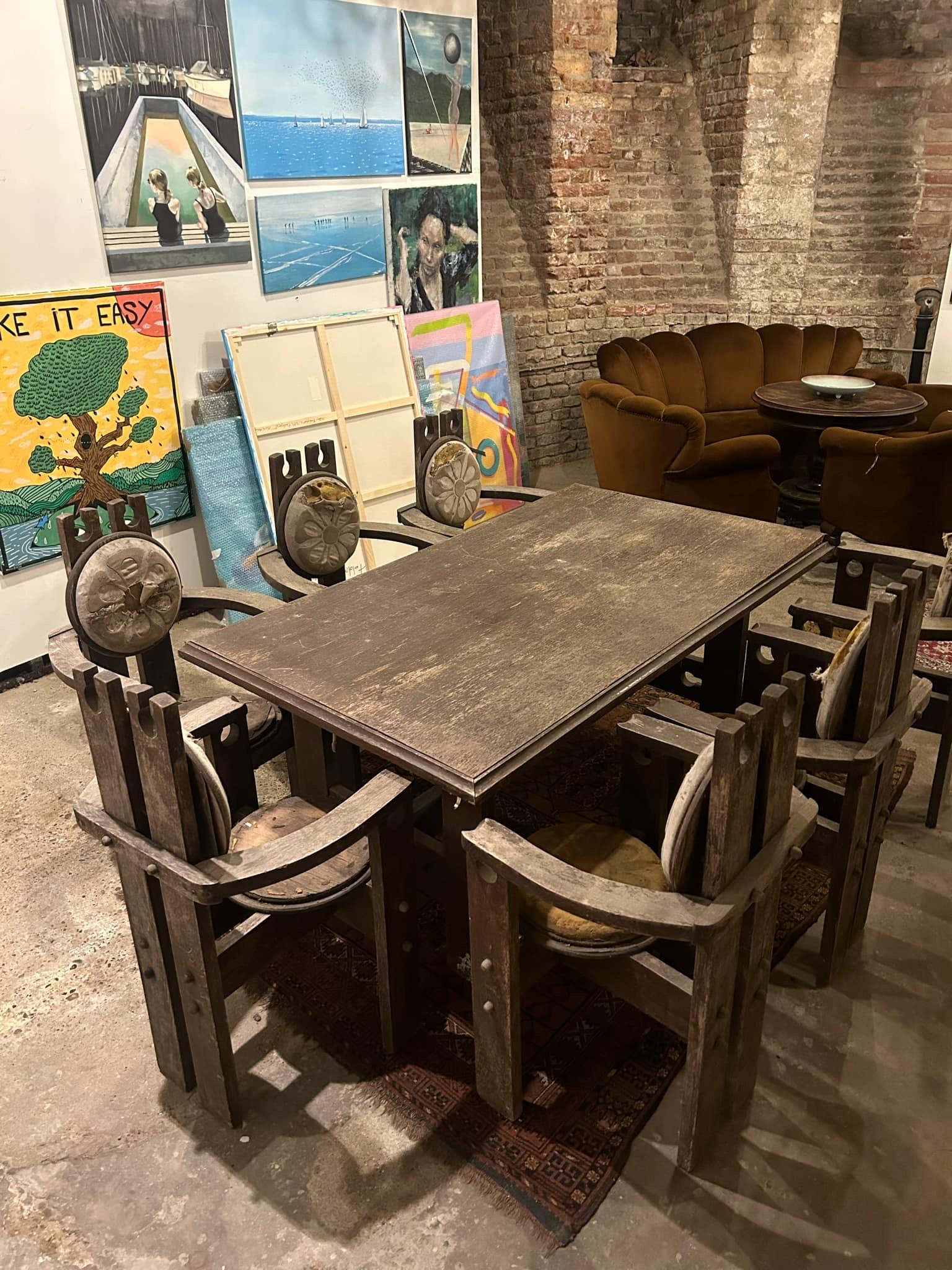 This dining set, crafted from solid oak, consists of 8 chairs and a matching table, exuding a distinctive rustic charm. A perfect centerpiece for a dining area with character, this set offers a unique vintage aesthetic.

While structurally stable,