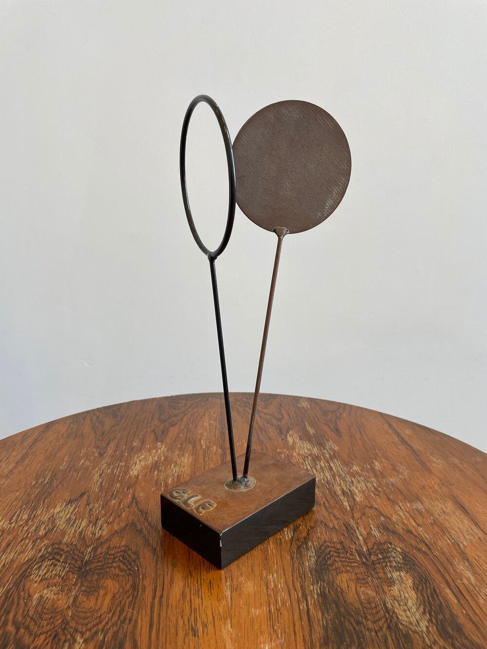 Brutalist disc and open circle sculpture Signed GLE on base

Additional information:
Materials: Steel
Period: 1950’s
Condition: In vintage good condition
Place of origin: Unknown
Dimensions: 14” H x 6” W x 5” D.