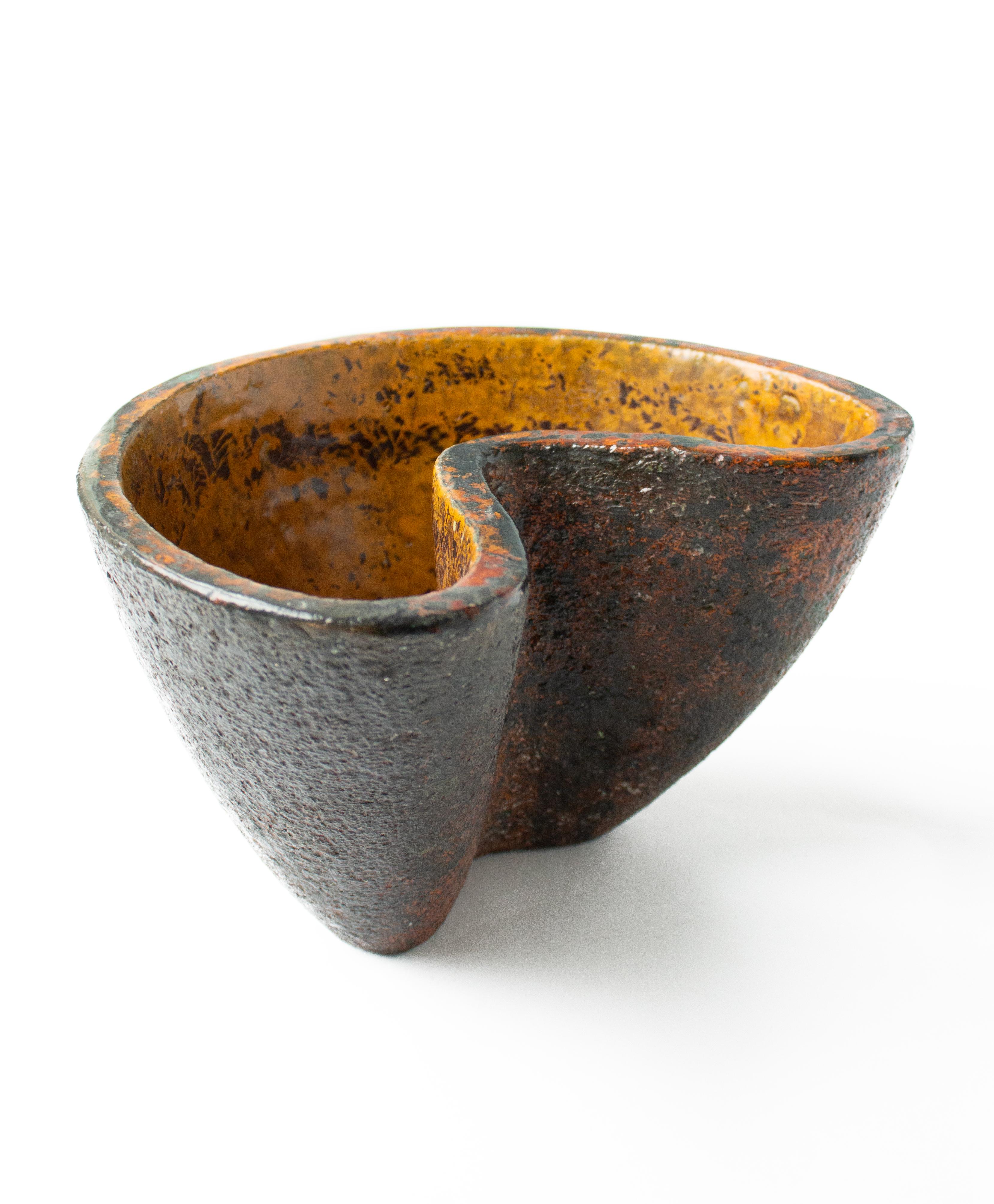 Brutalist Vase in Yellow, and Orange by Hans Hedberg, Biot France. Asymmetric form  in high-fired earthenware with mottled glaze in red, orange, and brown-black tones. Monogram signed HHg.  D ca 26, W 21, H 15,5 cm

Hans Hedberg (1917–2007) was a