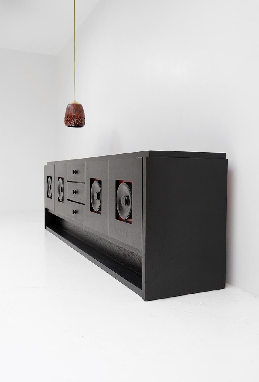 De Coene, Brutalist, Belgium, 1970s

This black Brutalist sideboard that is very sturdy build and contains in a well preserved condition. Each door panel has a graphic circle shaped doorknob, that is next to functional also the eyecatcher to this