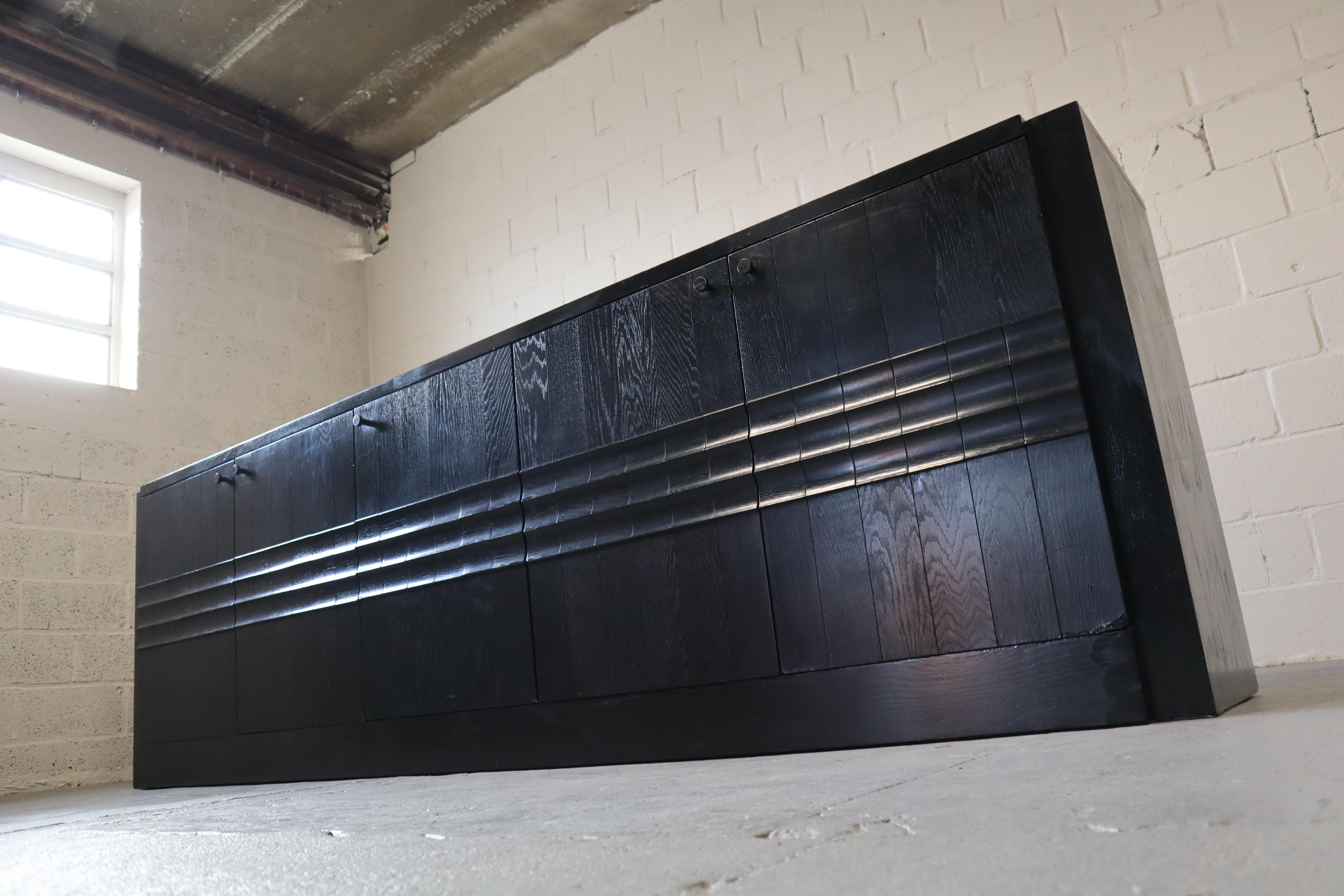 Brutalist ebonized sideboard with five graphical door panels, 1970's.
Ebonized Oak veneer!

The sideboard has a lot of storage space and features 5 doors and 2 drawers