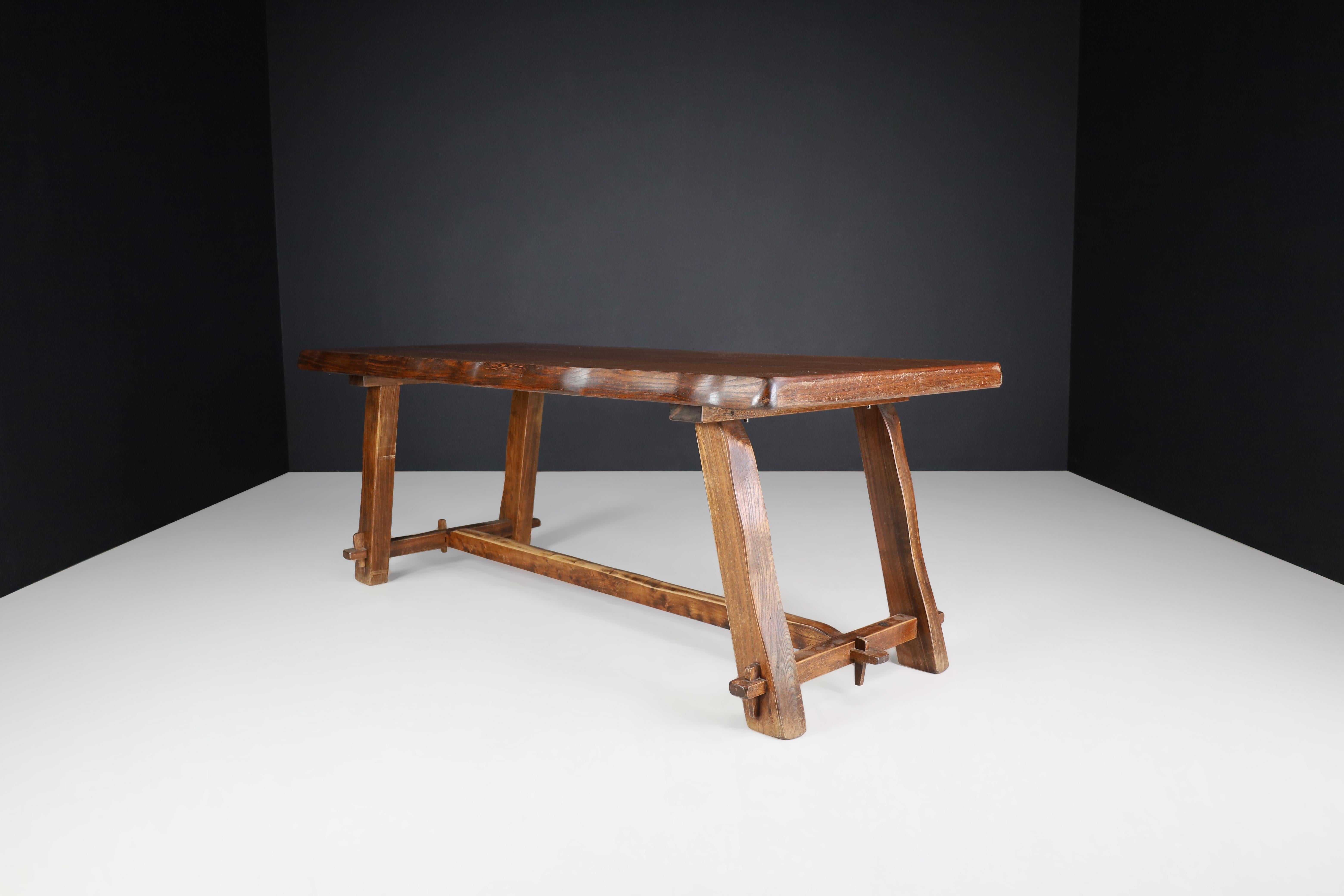 Brutalist elm dining table by Olavi Hanninen and edited by Mikko Nupponen in Finland in 1959

This Brutalist elm dining table was designed by Olavi Hanninen and edited by Mikko Nupponen in Finland in 1959. It is a versatile piece of furniture that
