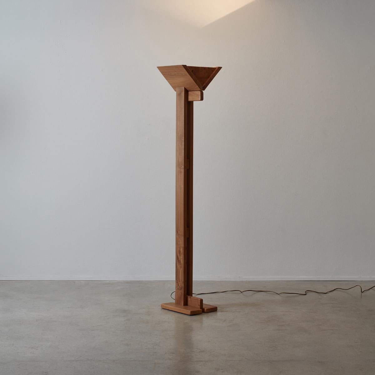 This Brutalist floor lamp made from solid elm is pared back and striking. Created using thick pieces of elm which have been joined together in a skilful way. The lamp is primarily an uplighter that produces a large amount of light that bounces of