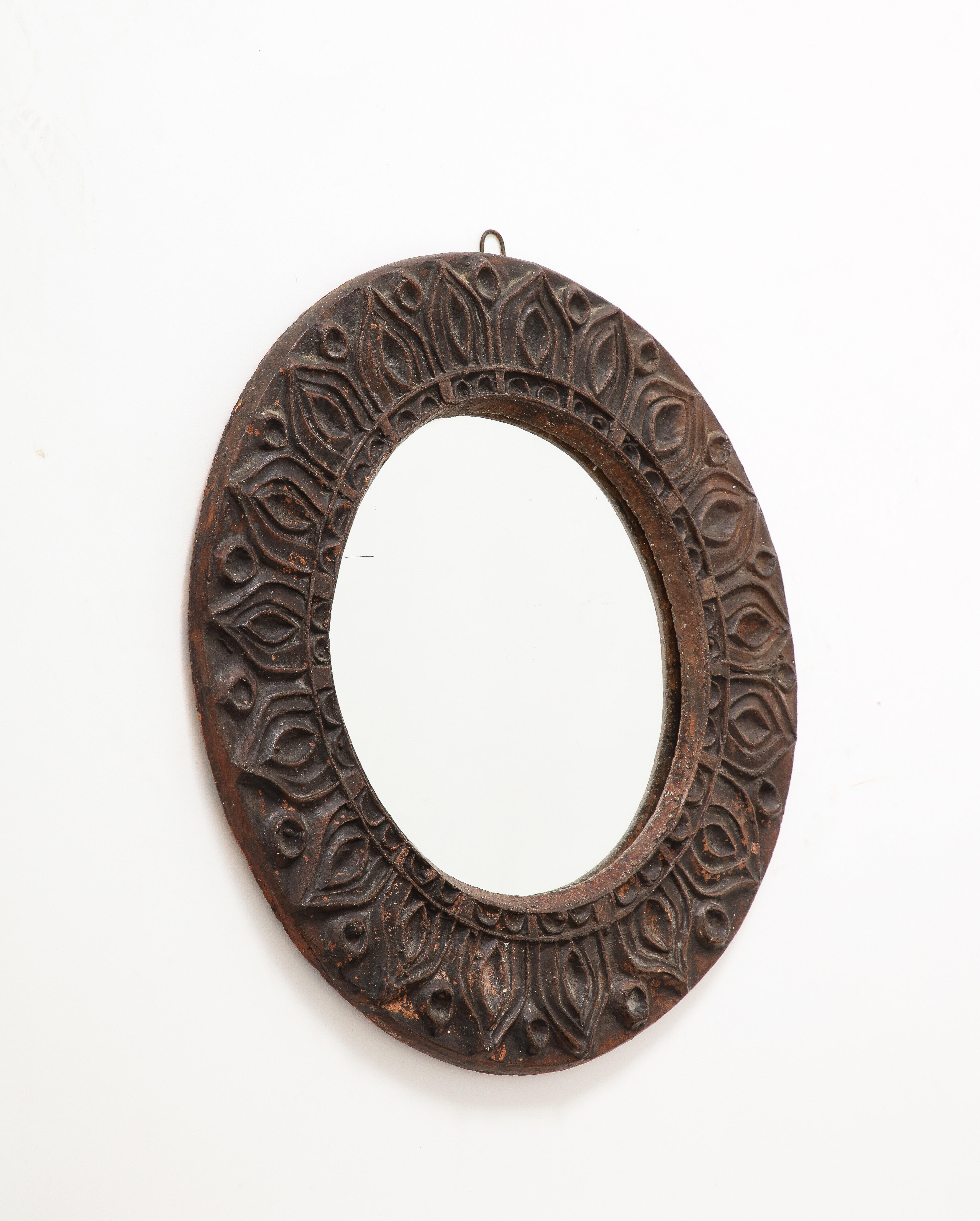 Dark brown etched terracotta mirror. Possibly from Vallauris, France.
In fair vintage condition.

