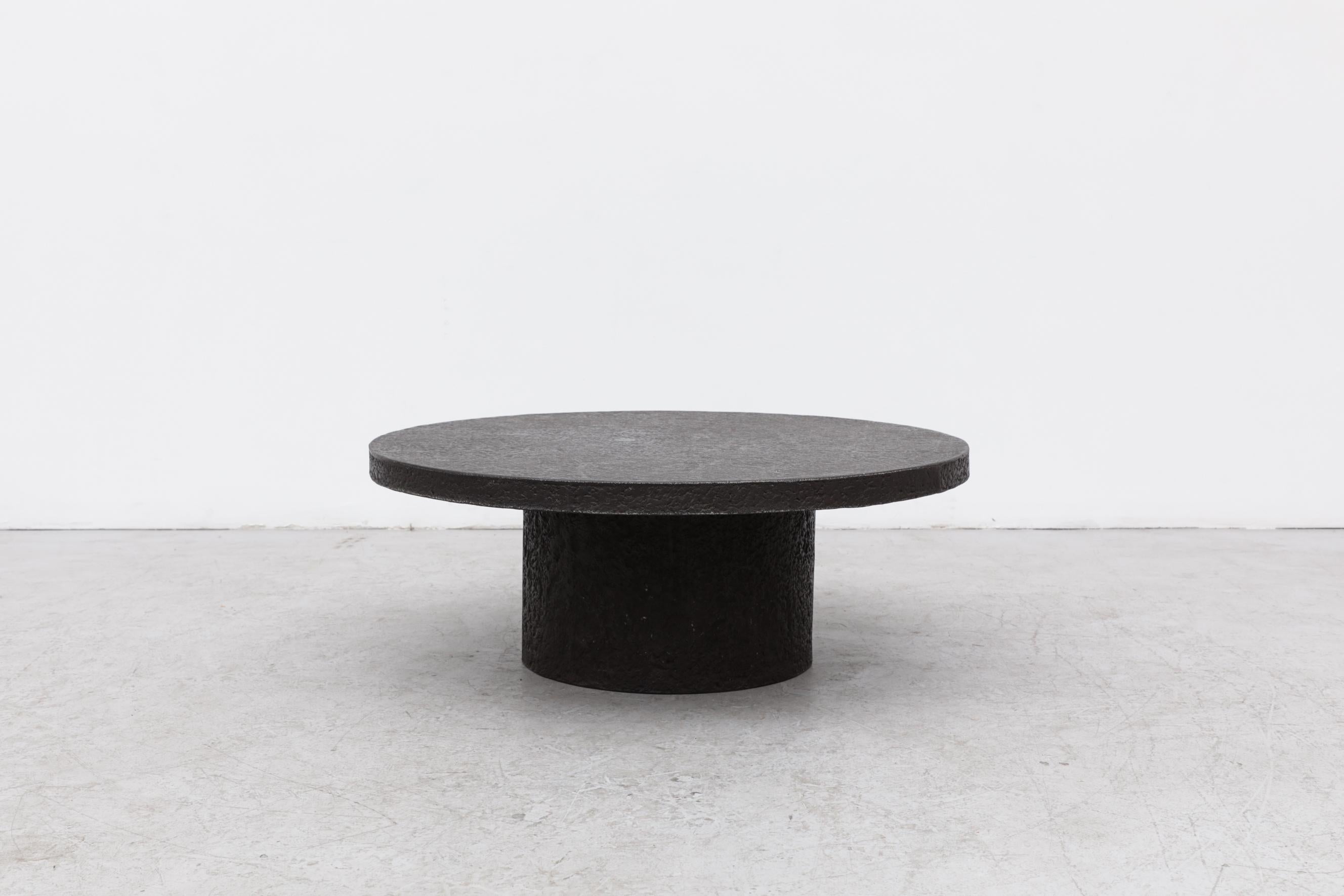 Round Brutalist faux lava stone coffee table with a pedestal base. In original condition with some wear consistent with its age and use. Other stone coffee tables are available and listed separately. (T442).