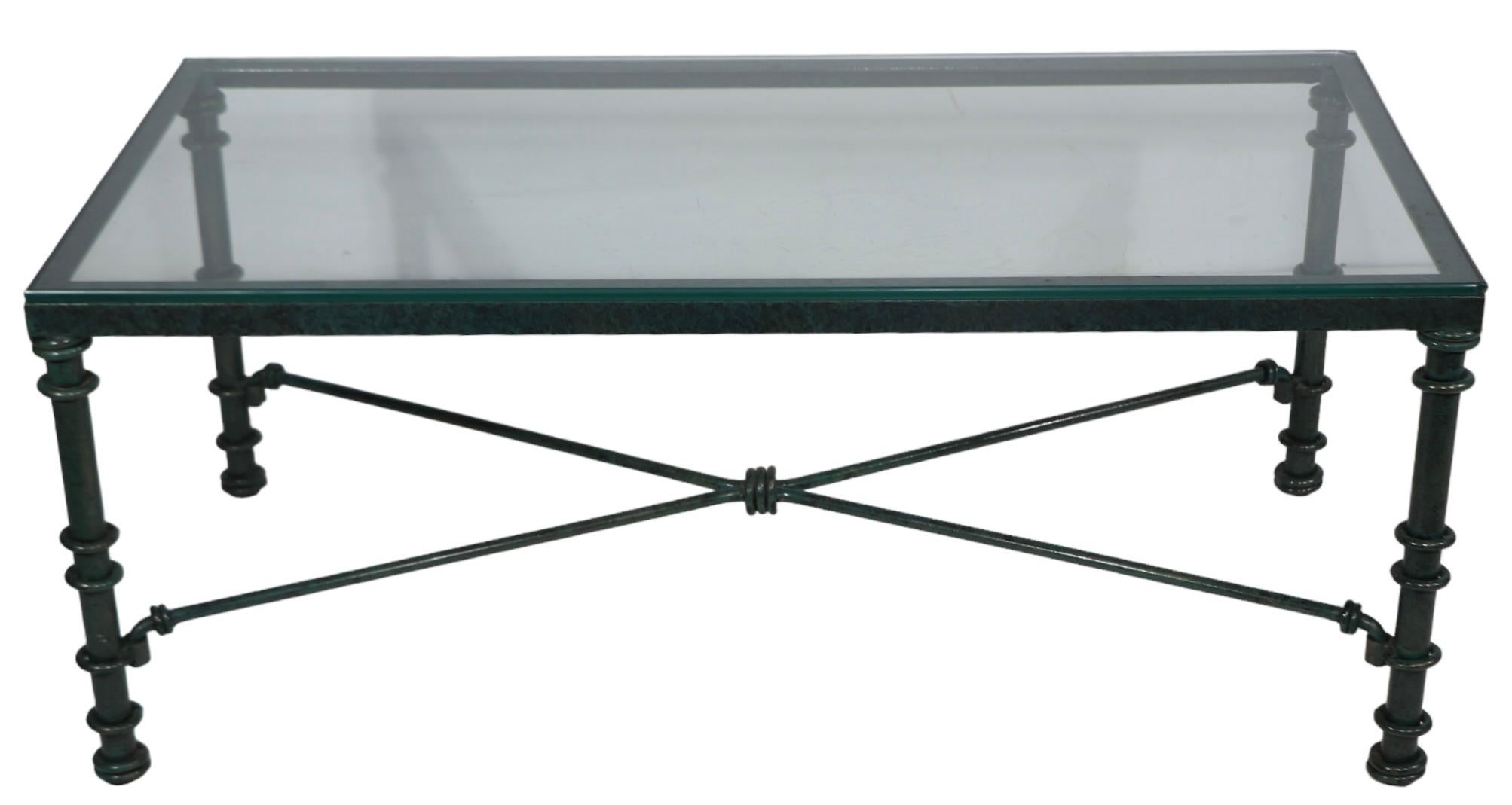 Voguish Brutalist coffee table in rich faux Verdigris paint finish, made in the USA c 1970-1980's. The table features a metal base in  original dark green and black finish, with a glass top. The paint finish is in excellent clean, ready to use