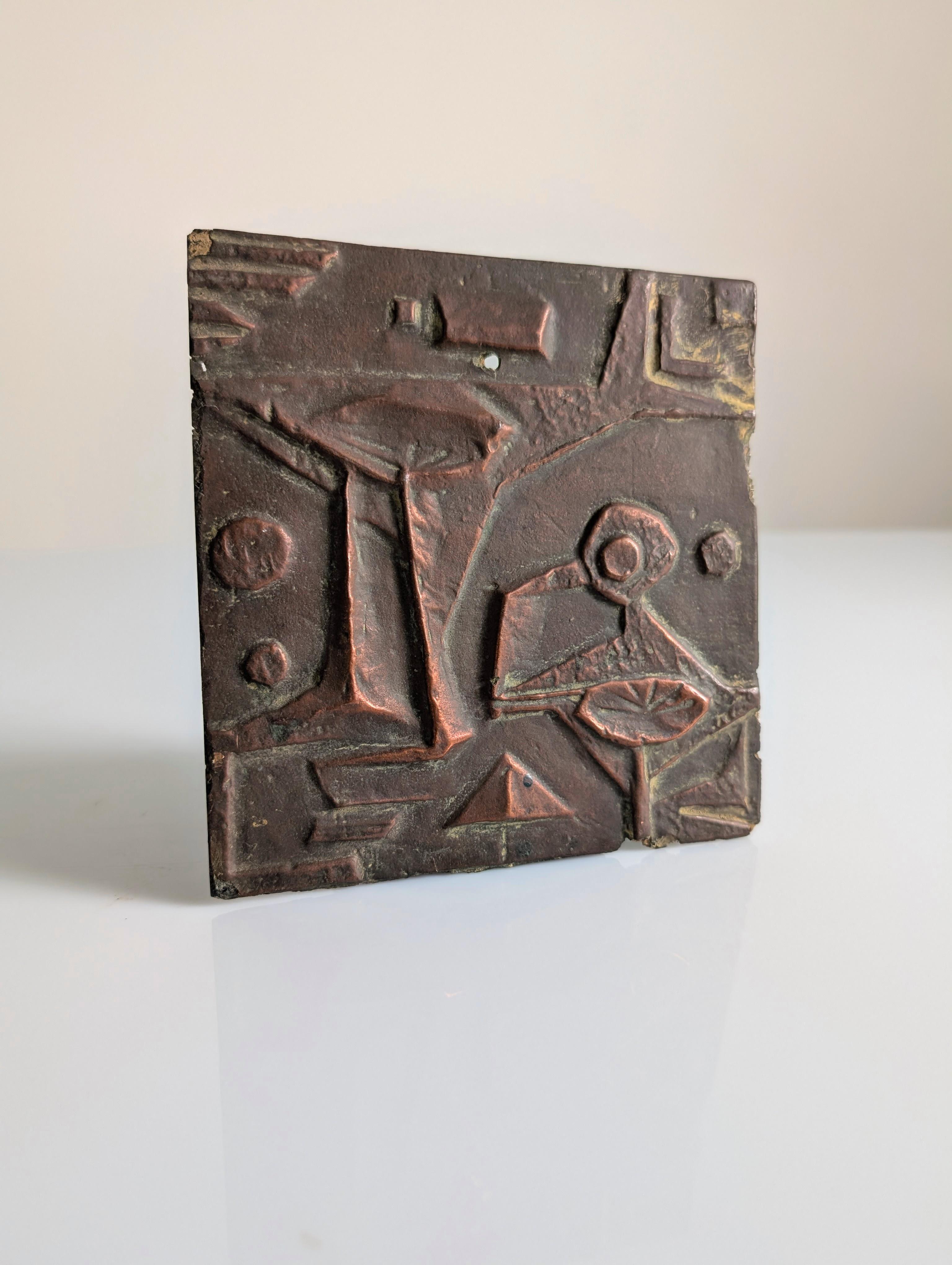 Brutalist relief plaque made of fiberglass in the 1960s, featuring an abstract surface of geometric shapes and incised textures. The patinated finish in copper and brown tones evokes the look of aged bronze, emphasizing the depth and structure of