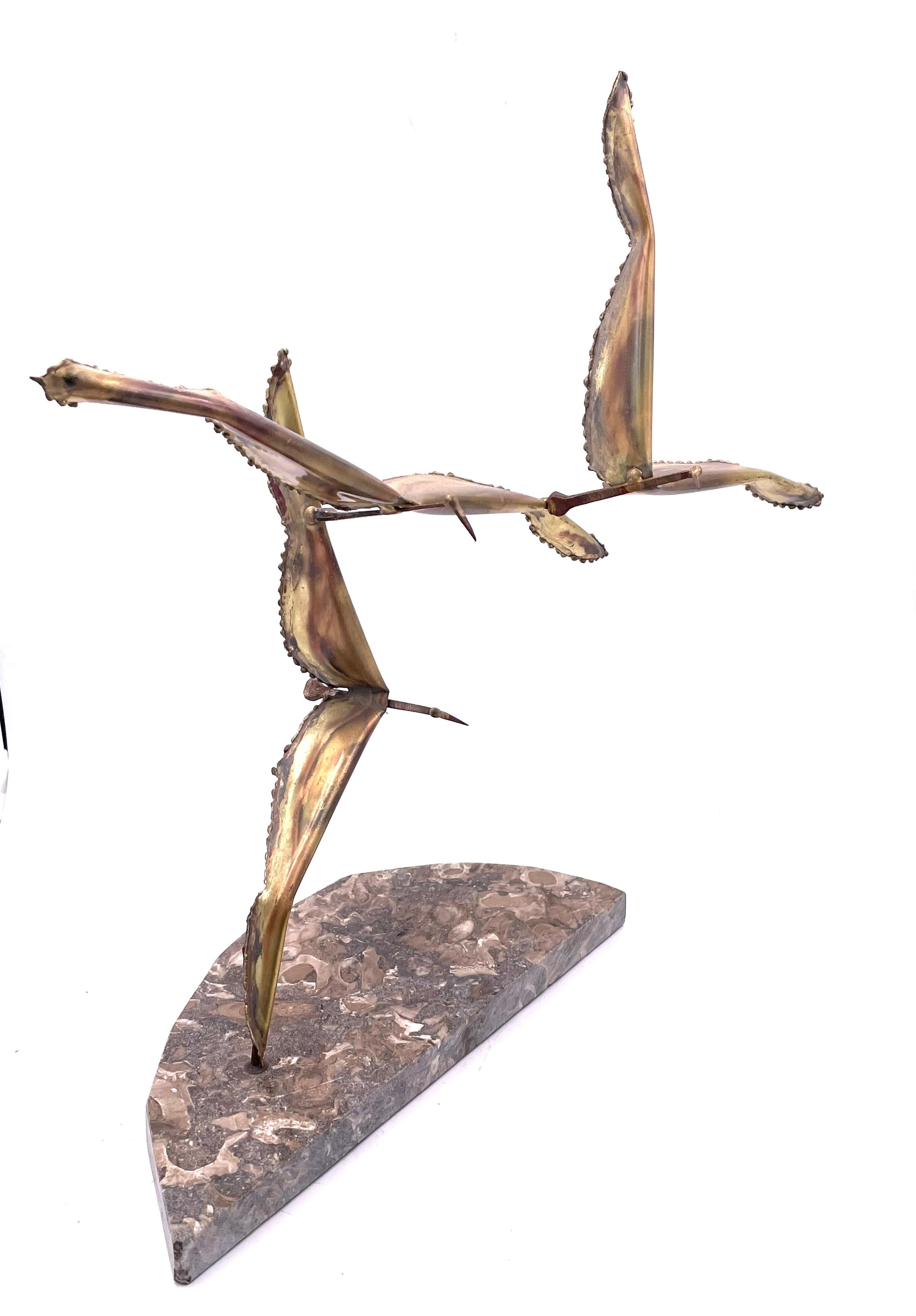 Beautiful brass & marble brutalist brass welded flying birds sitting on a marble base, circa 1970's.