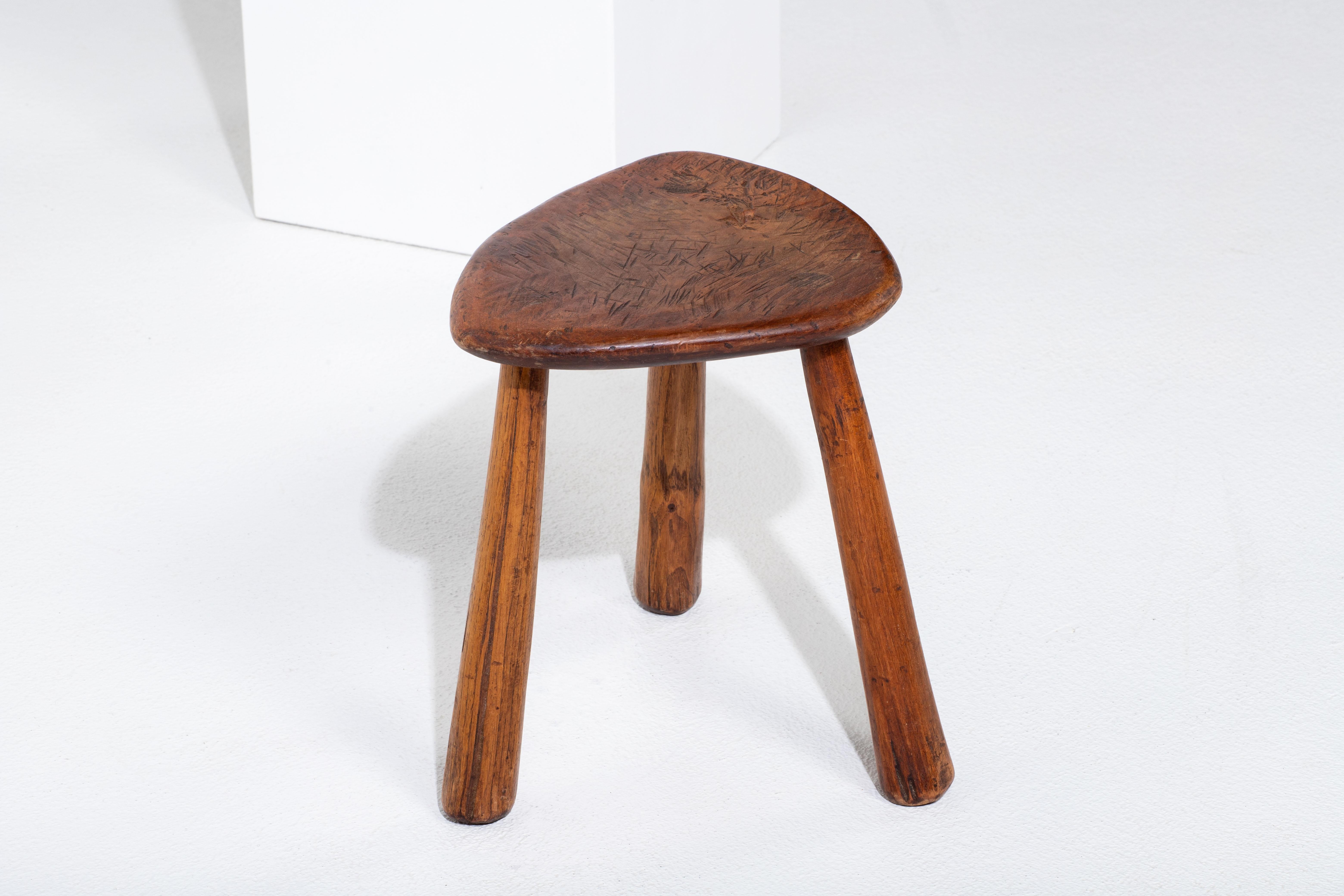 Introducing a captivating midcentury wooden stool, meticulously crafted in France during the vibrant 1960s. This extraordinary piece serves as a tribute to the era's commitment to artisanal excellence. Crafted entirely without the use of