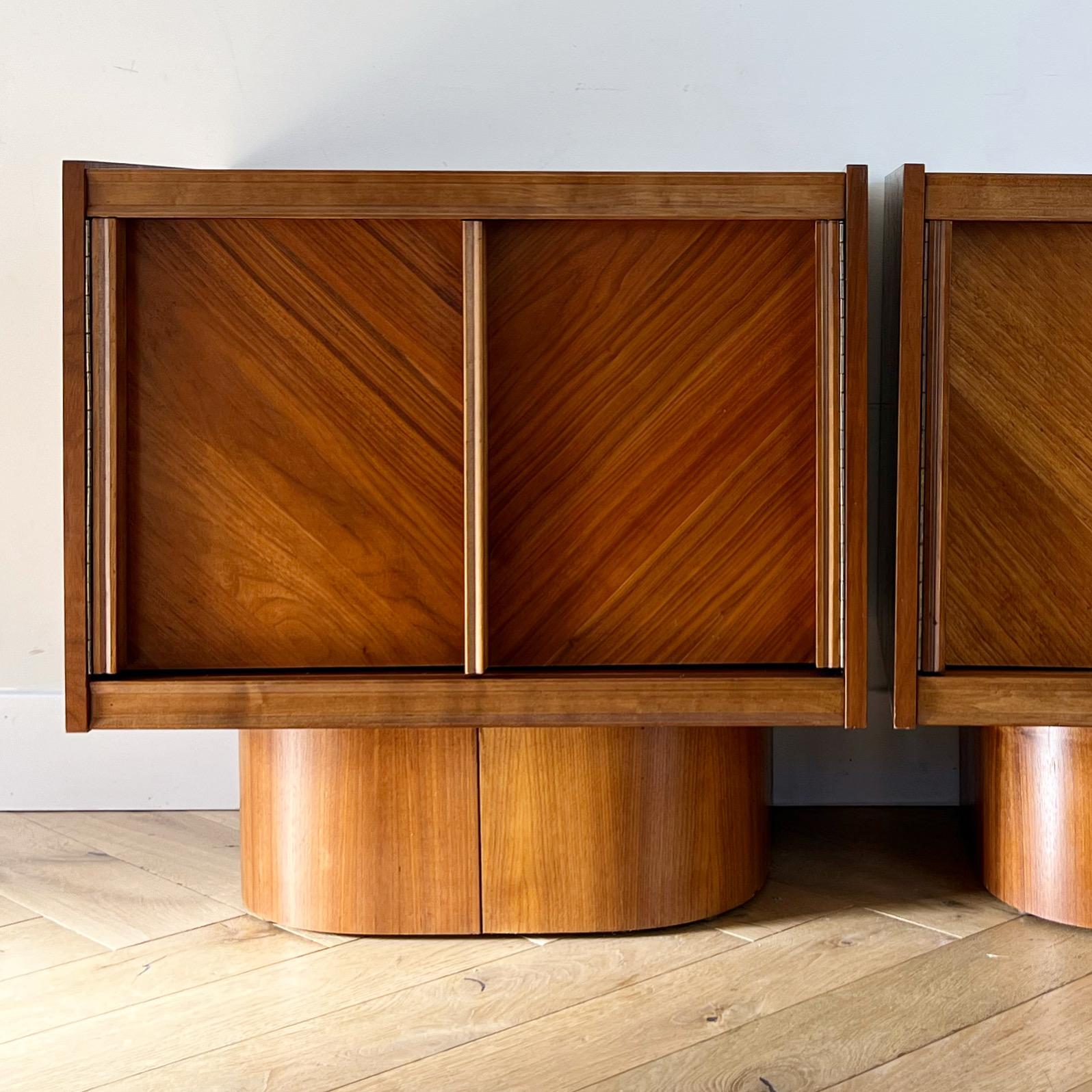 A stunning pair of mid century modern / brutalist nightstands in teak by Tabago, 1960s. Made in Canada. Bentwood curved bases uphold rectangular upper portions showcasing an exquisite wood grain and unique artisanal details. The highly geometric