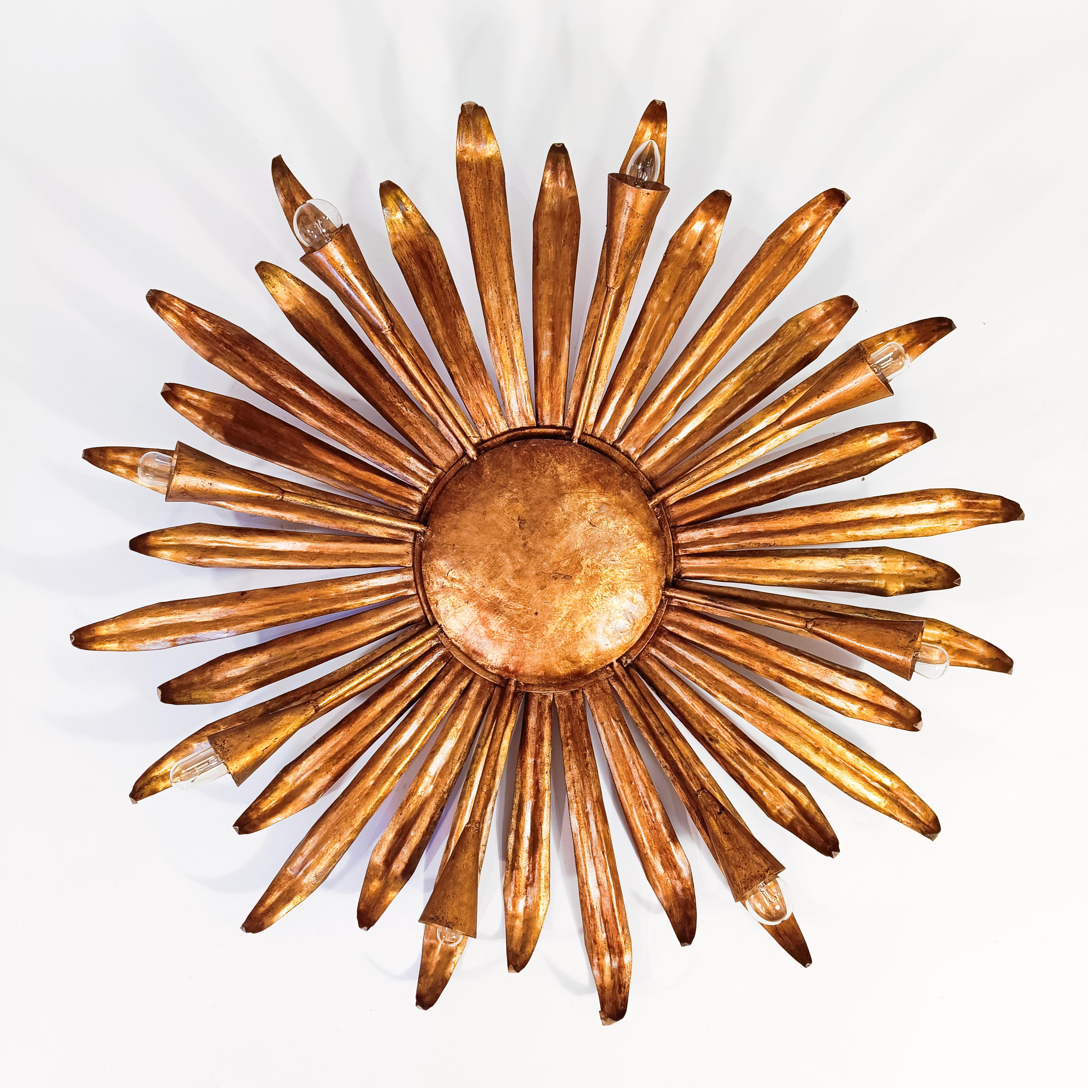 Huge brutalist sun-style flush mount by Ferroarte, Spain, 1960s. Metal structure formed by a circular base of wrought iron where different leaves or rays of sunlight of various sizes are welded as a crown around its perimeter. There are also 8-arm