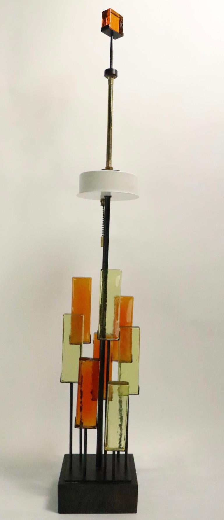 Rare glass block and wrought iron table lamp, design attributed to Gerald Thurston, for Lightolier. This example is in excellent original condition, clean, working and ready to use, it accepts three standard size screw in bulbs, which operate