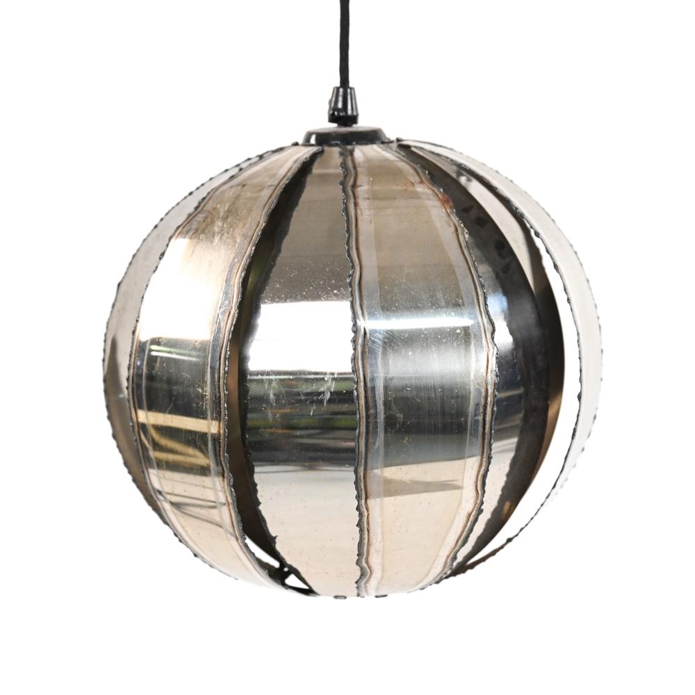 A rare departure from the copper and brass tones typical of Brutalist-period lighting, this chromed steel pendant effortlessly adapts to the Contemporary color palettes of today. Dating from the 1960's or 1970's, this lamp's style echoes that of