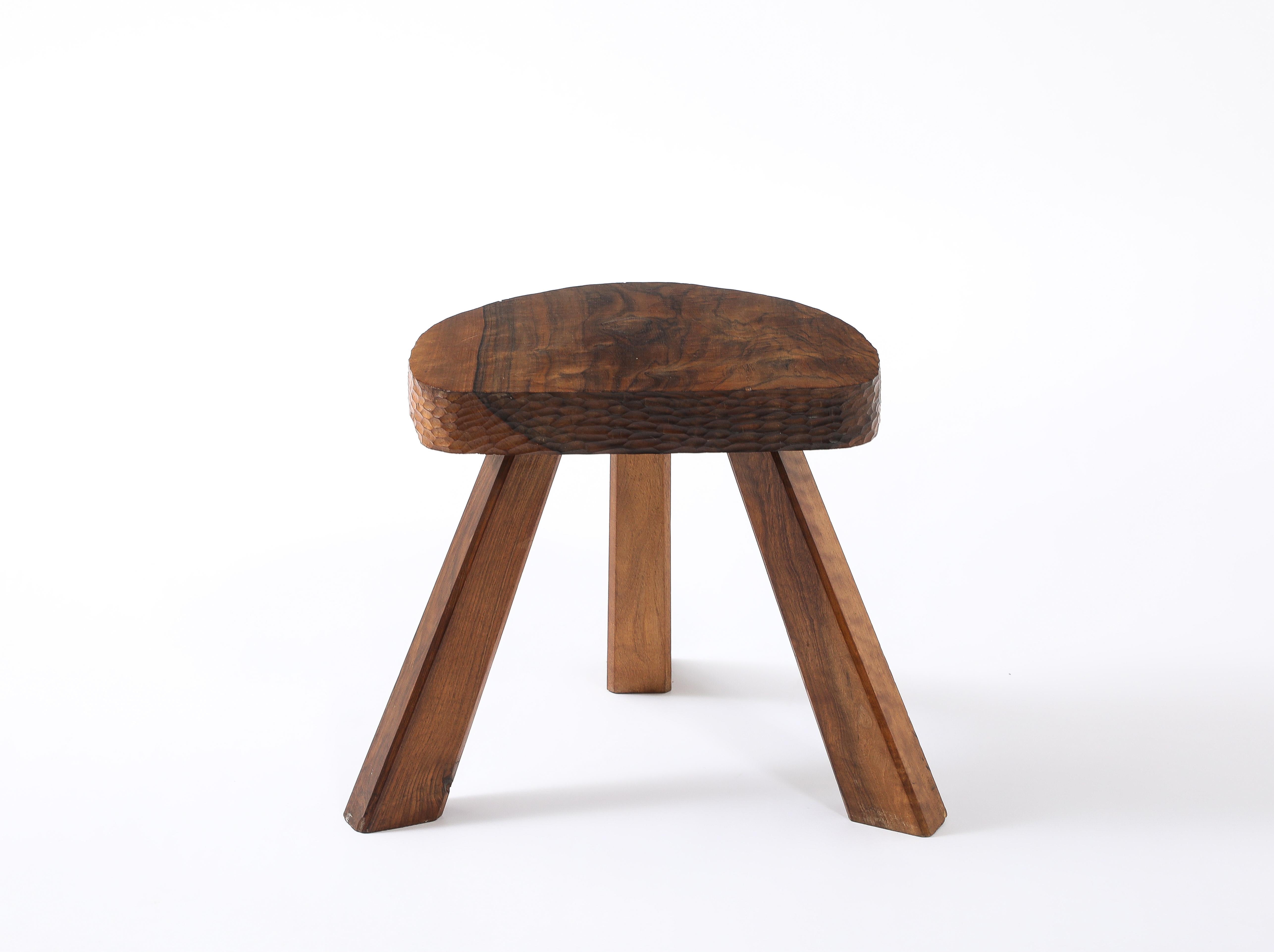 Solid black walnut stool with a gouged apron.