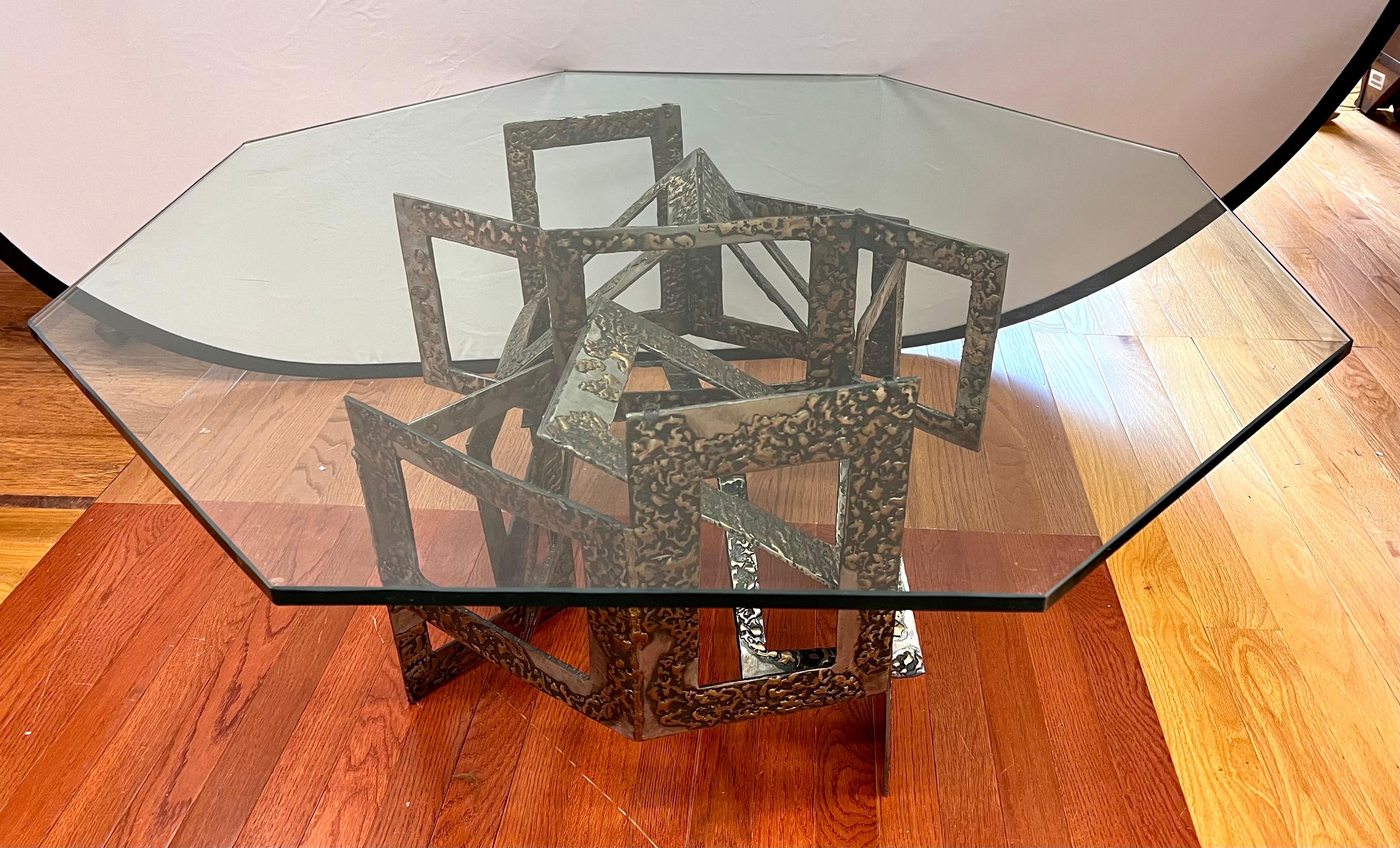Introduce a bold statement piece to your living room with this midcentury Paul Evans Style Brutalist Coffee Table. Inspired by the iconic design of Paul Evans, this table exudes a unique and daring aesthetic. The sculptural metal base, crafted with