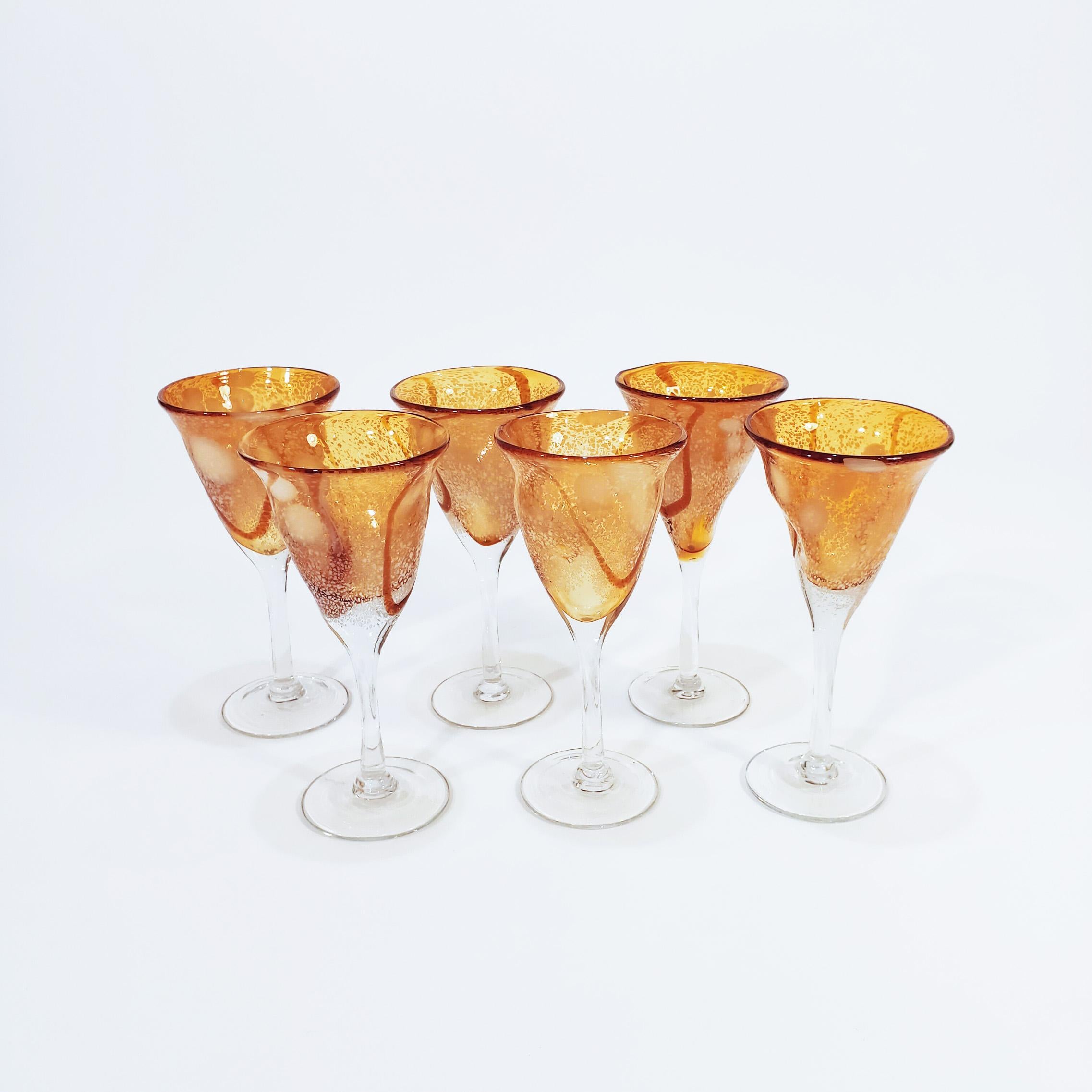 Set of 6 hand-blown Italian Murano glass set. Manufactured in the 70s, these cups are considerable in size and have a slightly brutalist style. Orange, caramel, white and transparent tones, with bubbles in the upper area of the bodies.
So much in