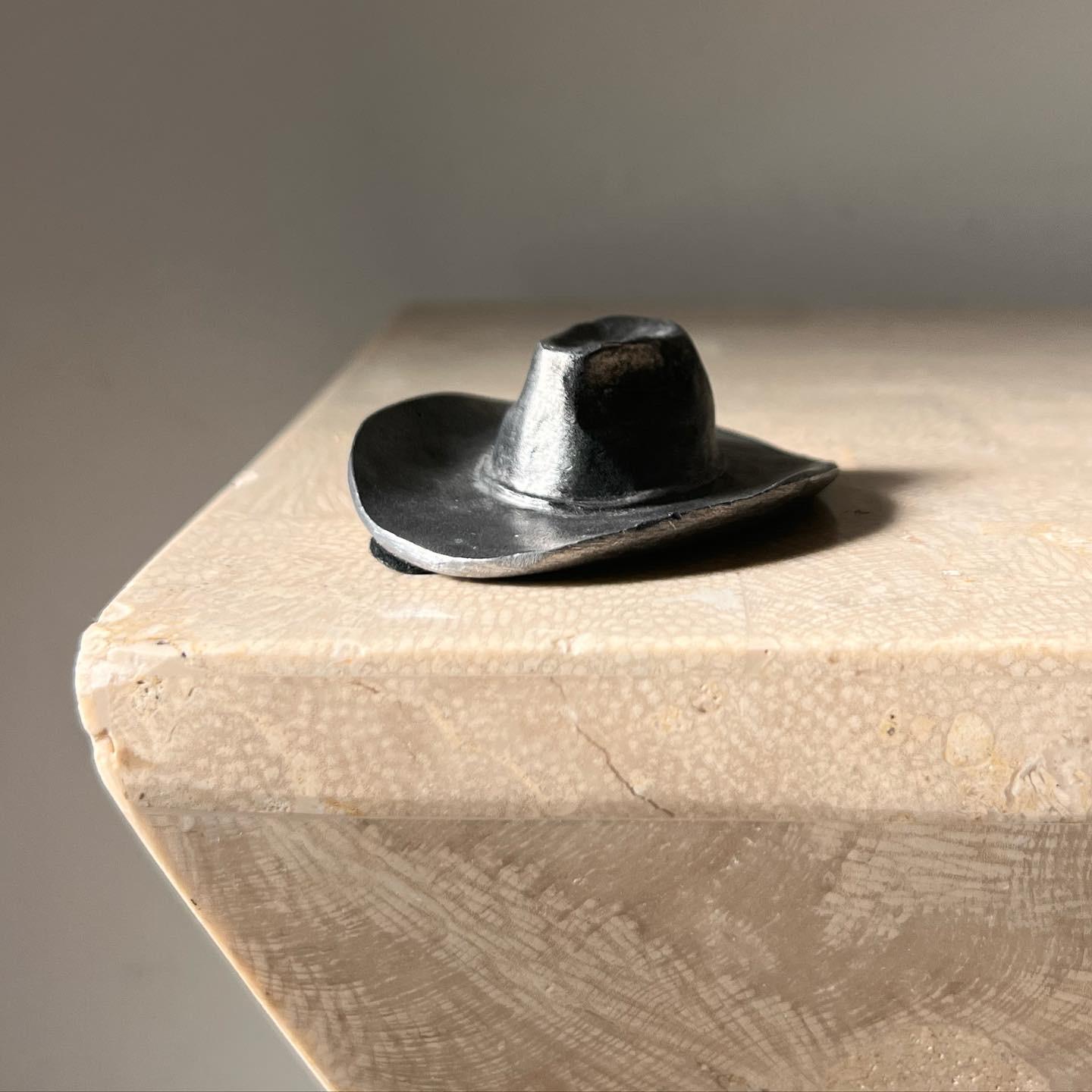 A vintage brutalist forged iron cowboy (or cowgirl) hat objet by Metzke, signed, 1970. Allegedly this is also an ashtray - or a paperweight. To each one’s own. Darling as a gift for your favorite western heartbreaker. Pick up in central west Los