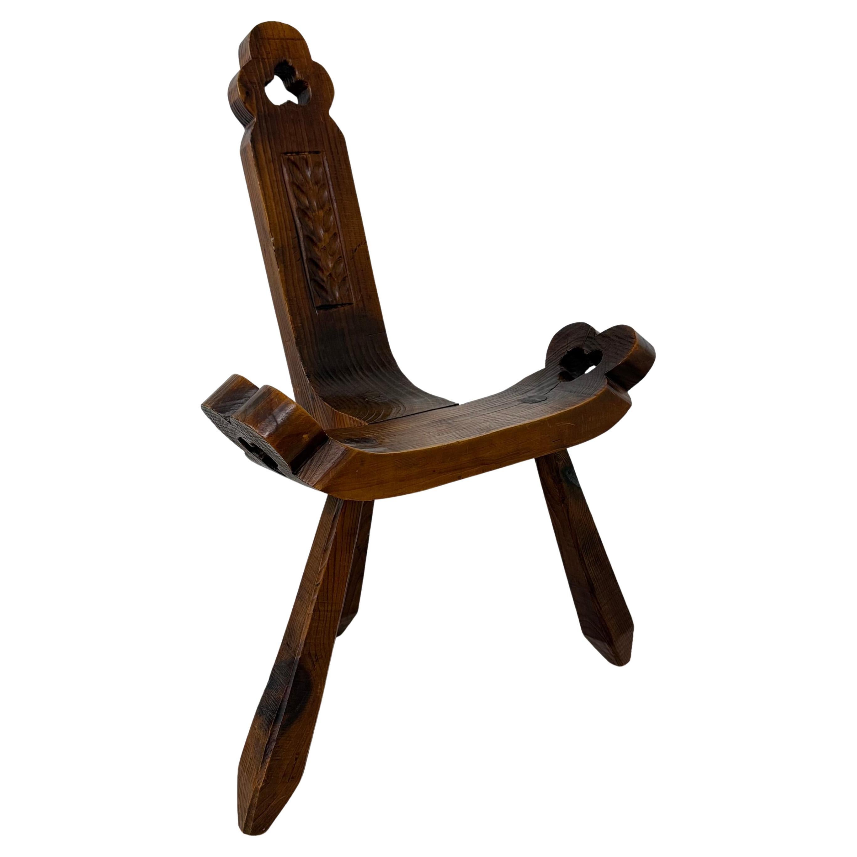 Brutalist hand carved oak Spanish tripod chair , 1970s For Sale
