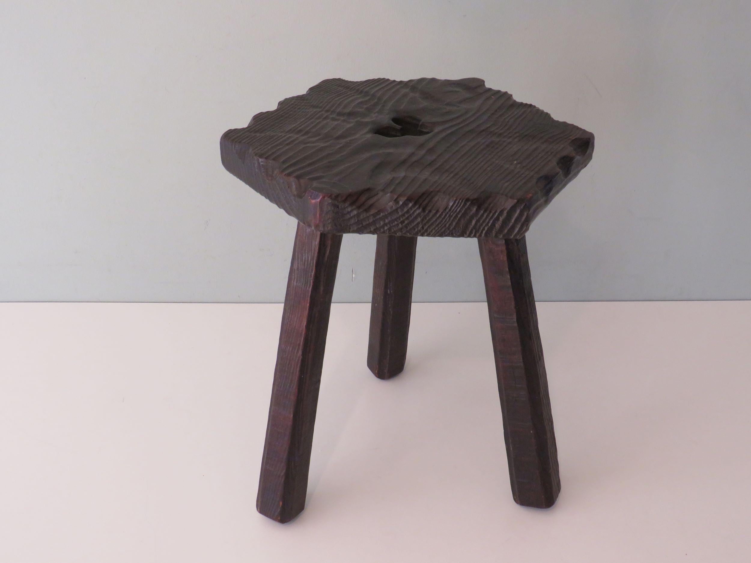 Dark wooden stool with sturdy legs and a hexagonal seat with a recess to pick up the stool.
Height: 37 cm, width 29 cm and depth 33 cm.